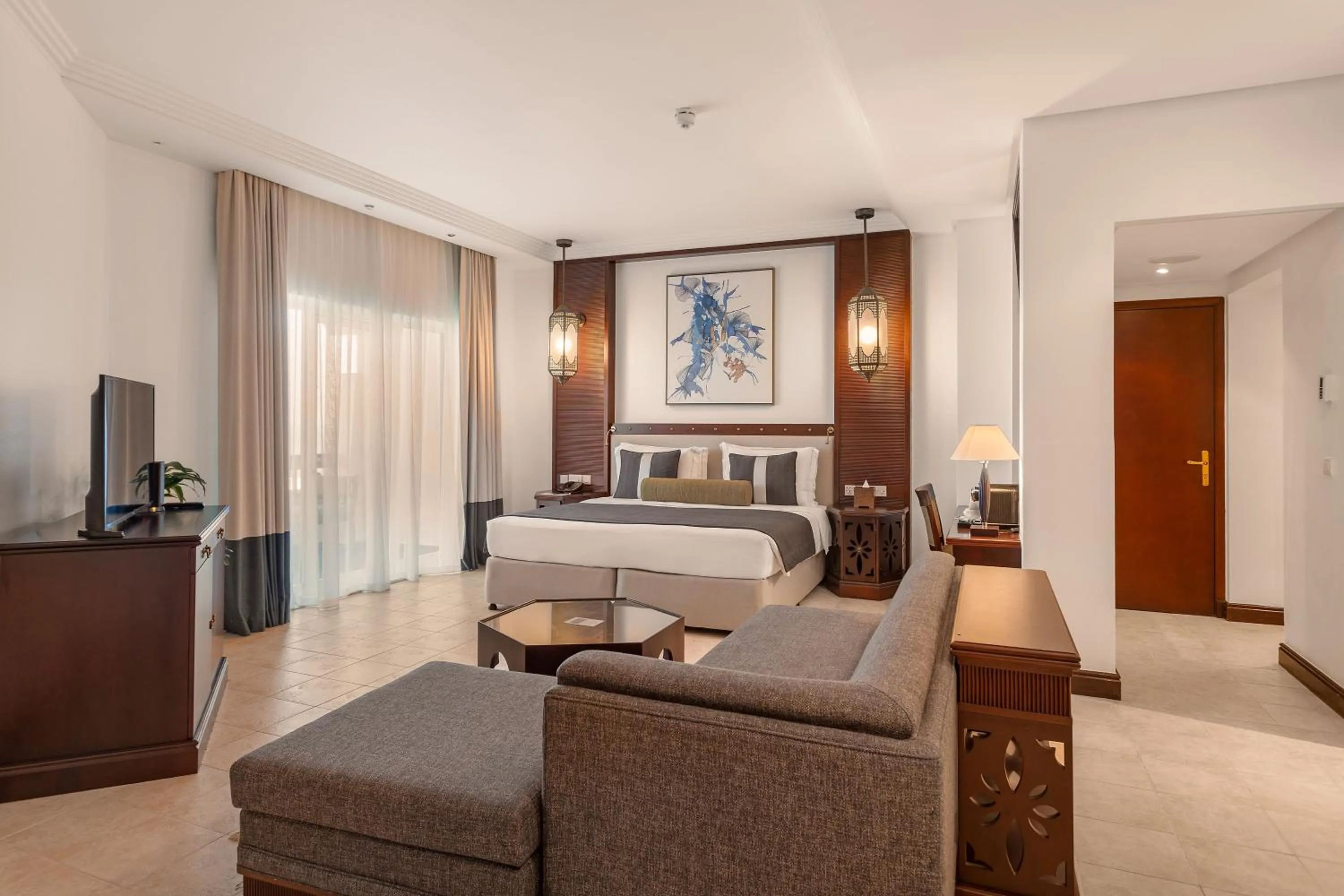 Communal lounge/ TV room, Bed in Ajman Hotel & Villas by Blazon Hotels