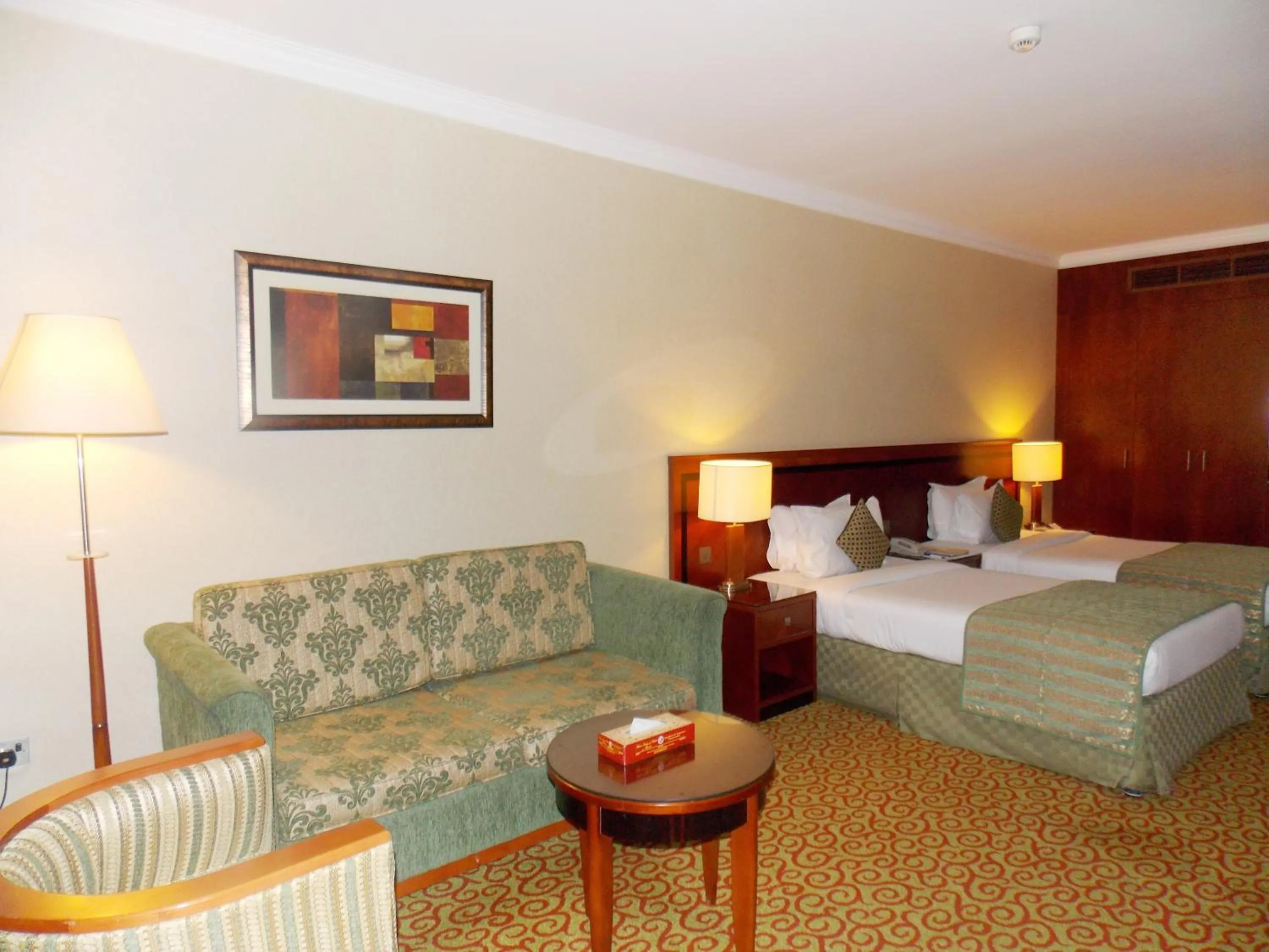 Seating area, Bed in Ramee Royal Hotel