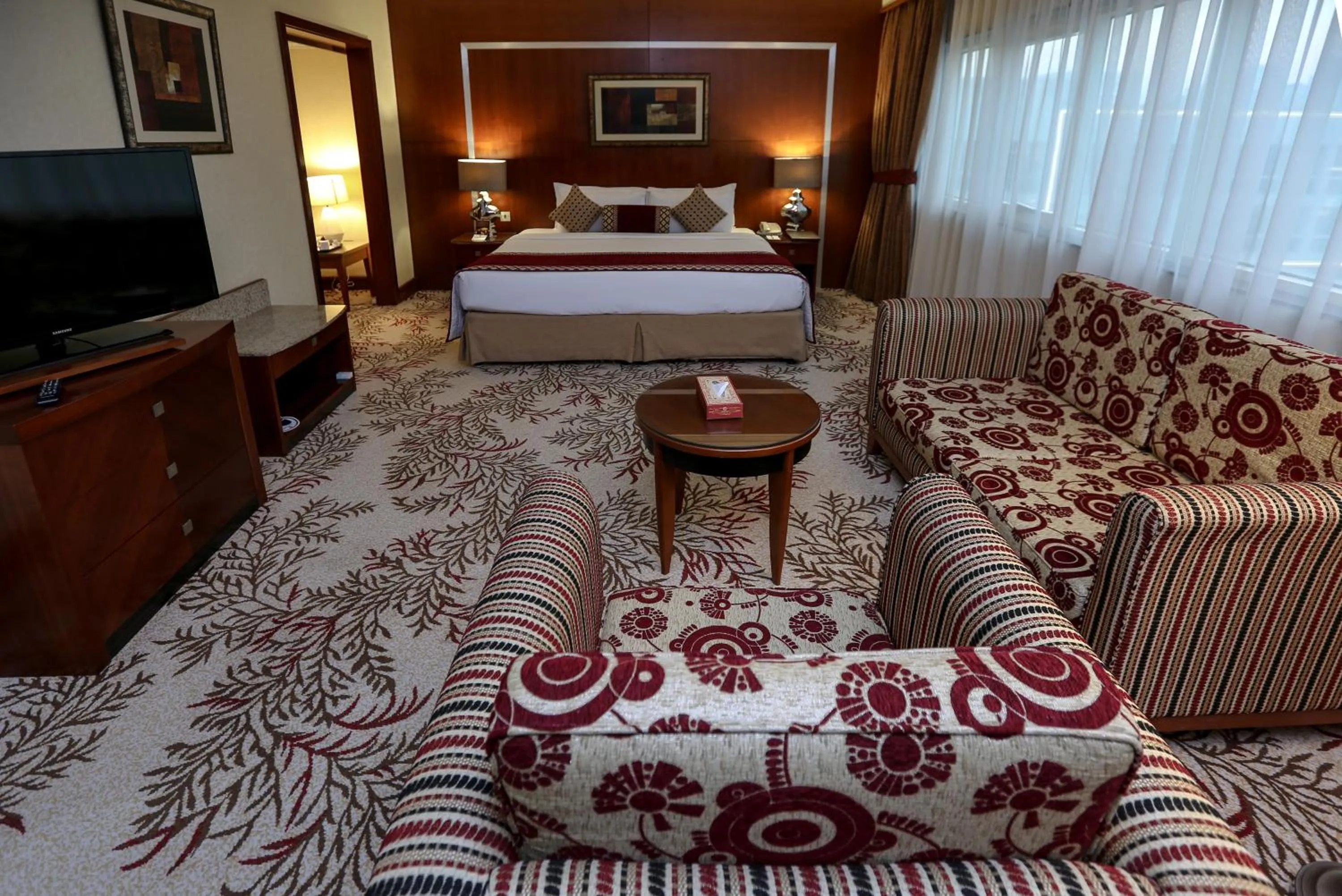 Seating area, Bed in Ramee Royal Hotel
