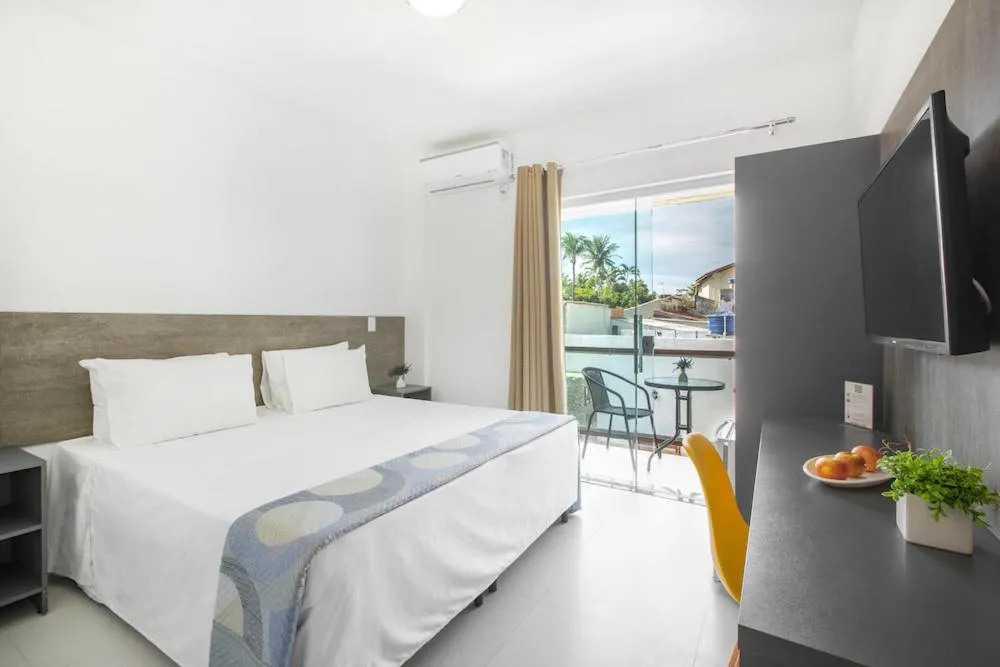 Bed in Hotel Cajueiro Guarujá