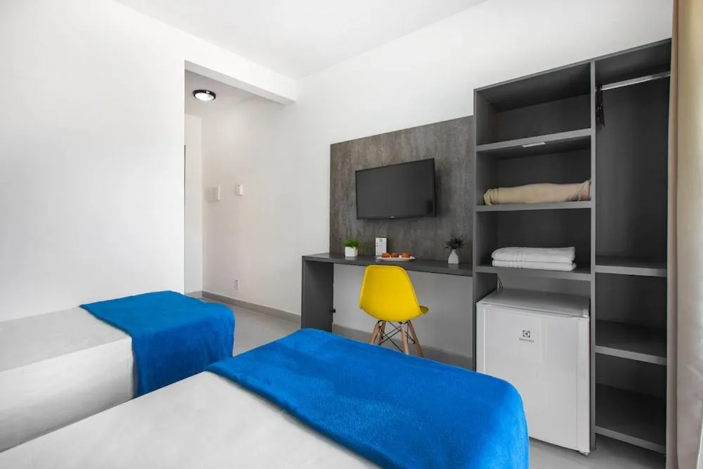 Bed in Hotel Cajueiro Guarujá