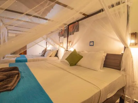 Bed in Frangipani Beach Villa