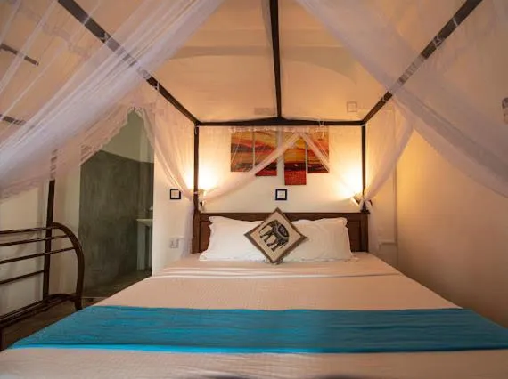 Bed in Frangipani Beach Villa