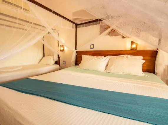 Bed in Frangipani Beach Villa