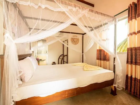 Bed in Frangipani Beach Villa