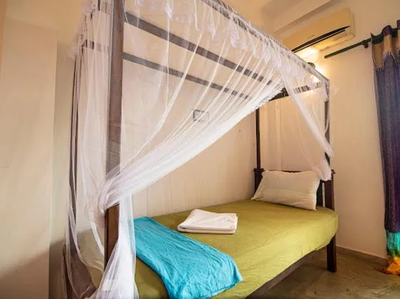 Bed in Frangipani Beach Villa