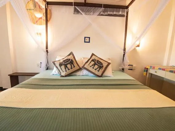 Bed in Frangipani Beach Villa