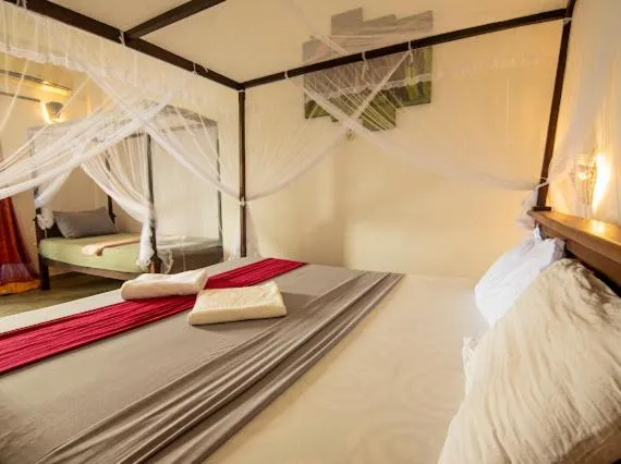 Bed in Frangipani Beach Villa