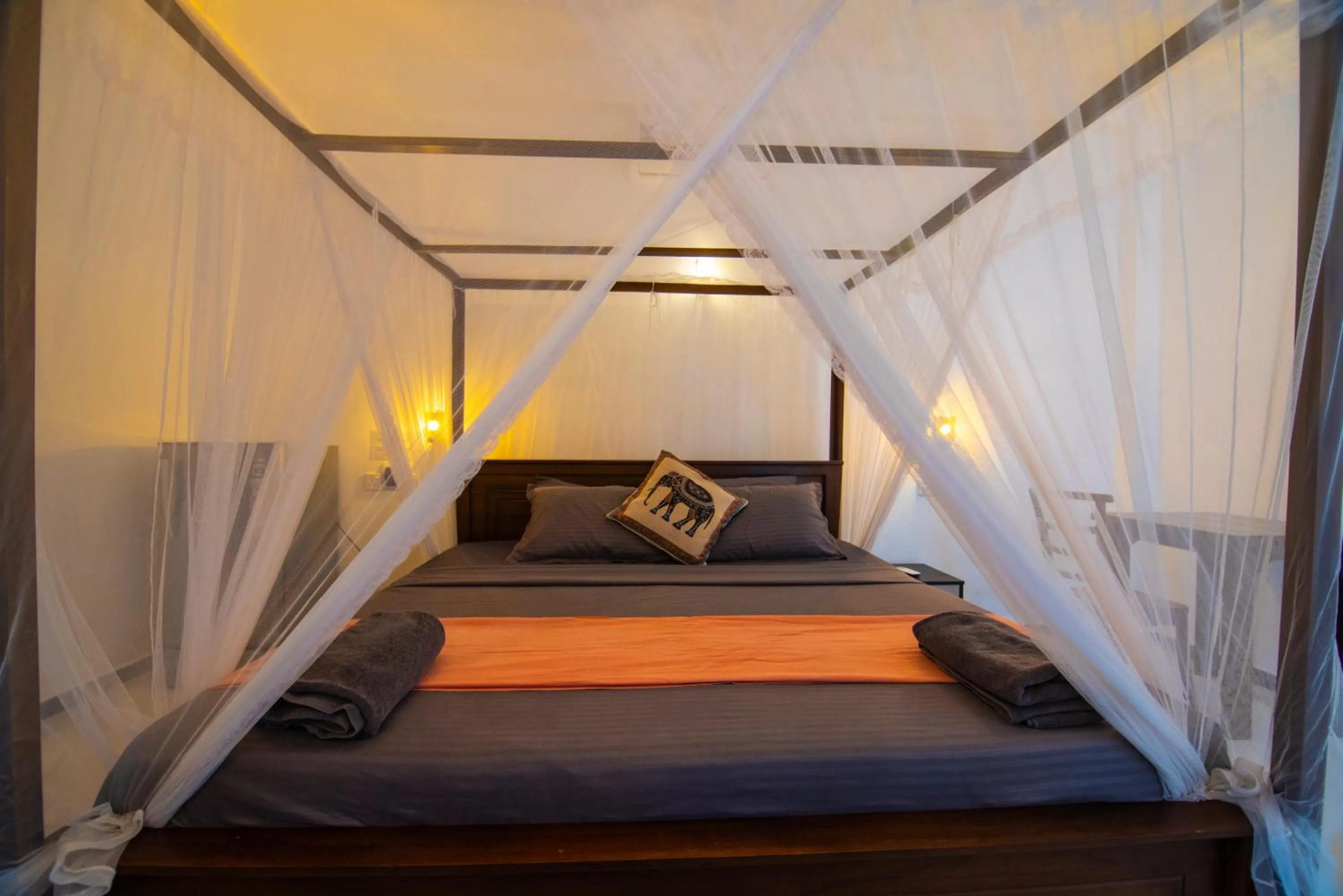 Bed in Frangipani Beach Villa