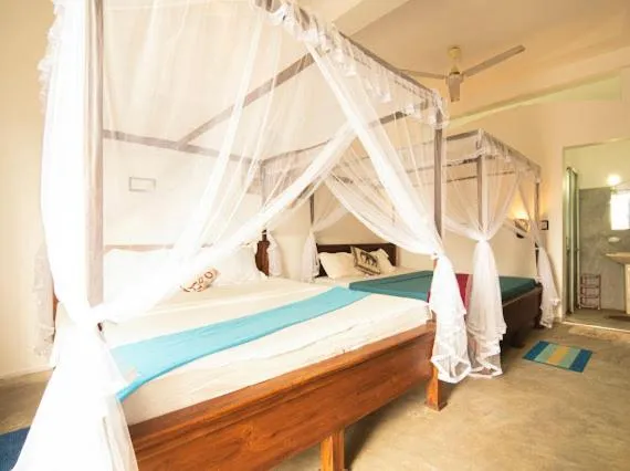 Bed in Frangipani Beach Villa