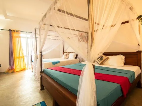 Bed in Frangipani Beach Villa