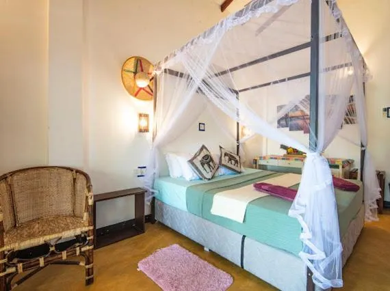 Bed in Frangipani Beach Villa