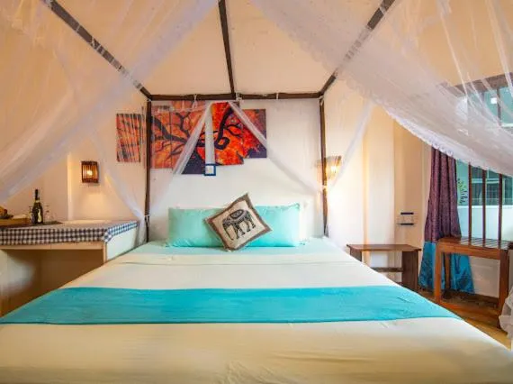 Bed in Frangipani Beach Villa