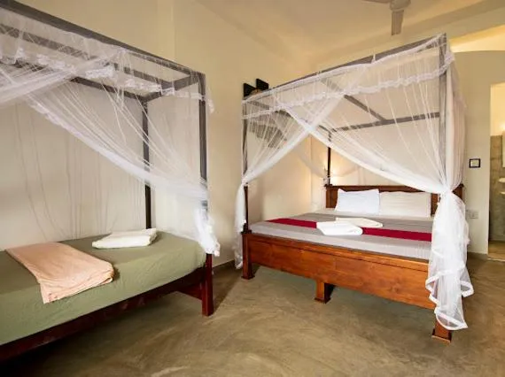 Bed in Frangipani Beach Villa