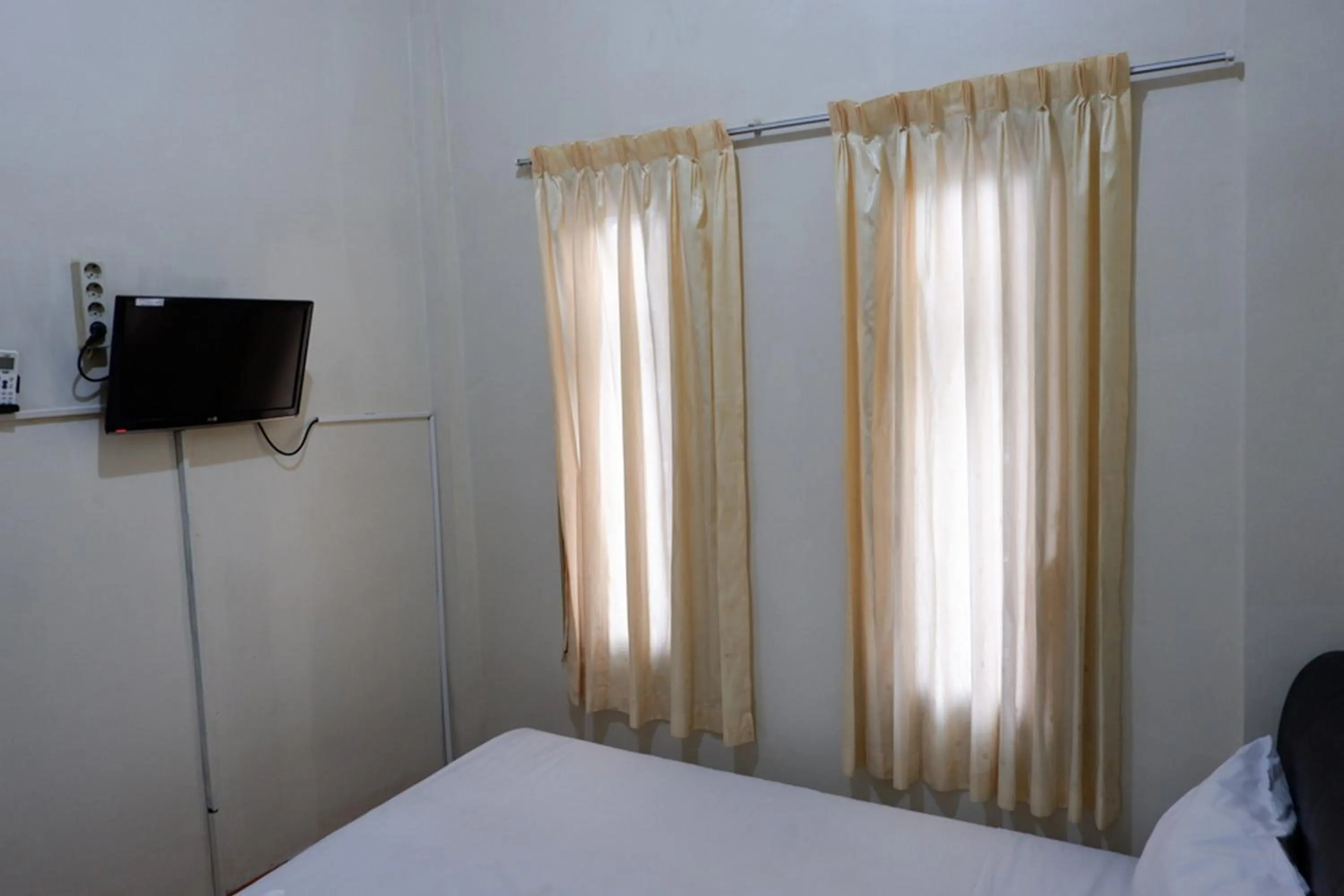 Bed in Khresna Guest House Malioboro Mitra RedDoorz