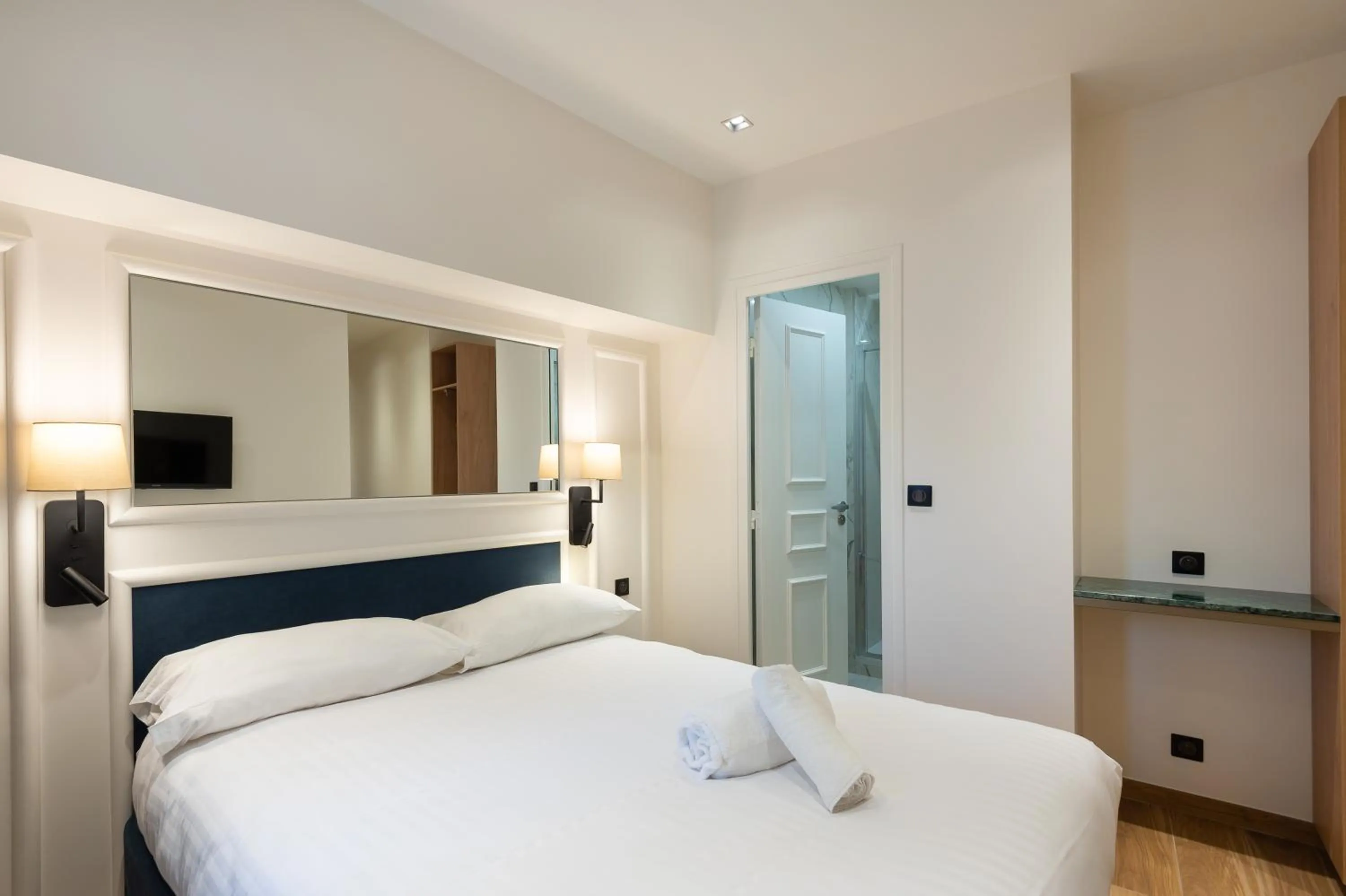 Bed in HOTEL AU COEUR DE REPUBLIQUE