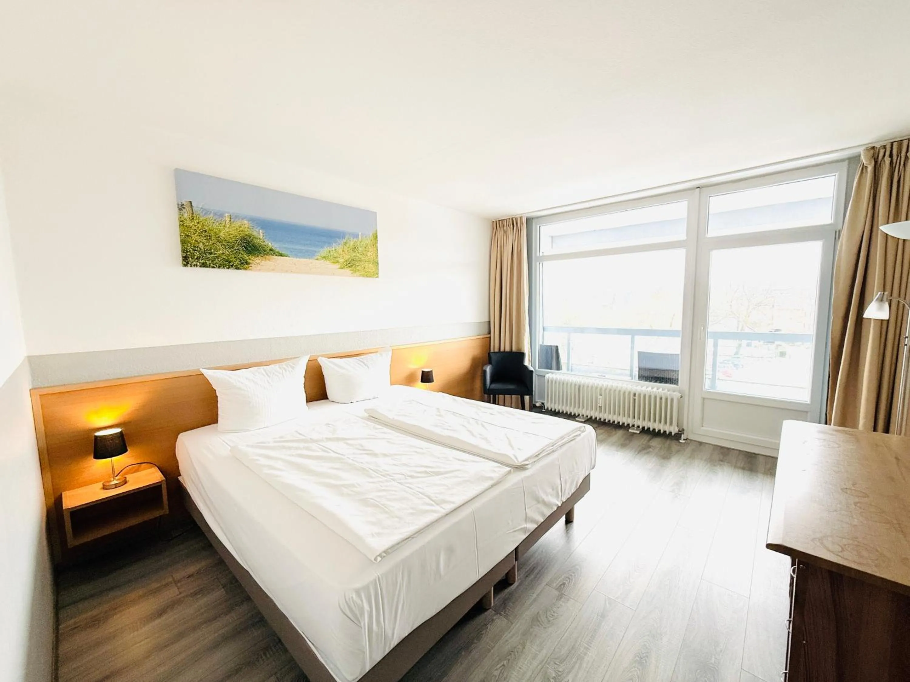 Photo of the whole room, Bed in Hotel Plöner See by Tulip Inn