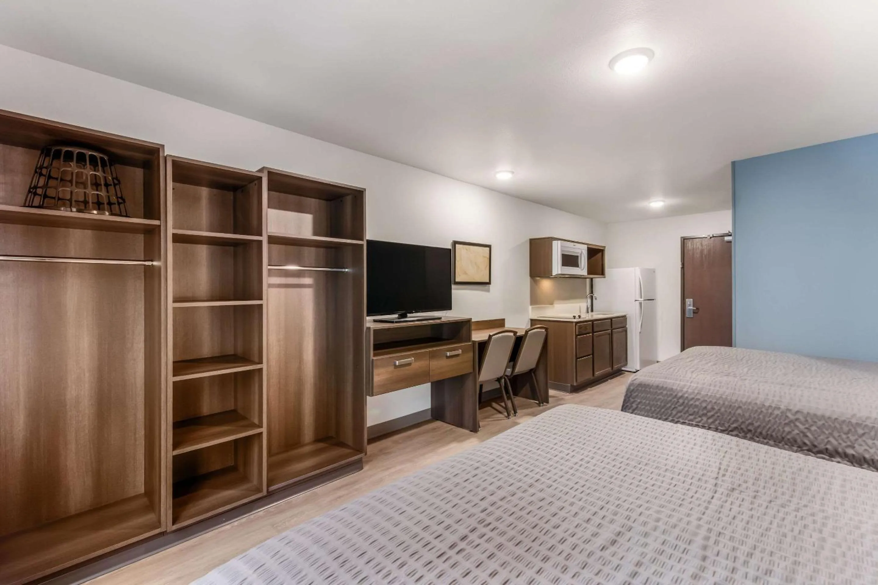 Bed in WoodSpring Suites Charlotte - University Research Park