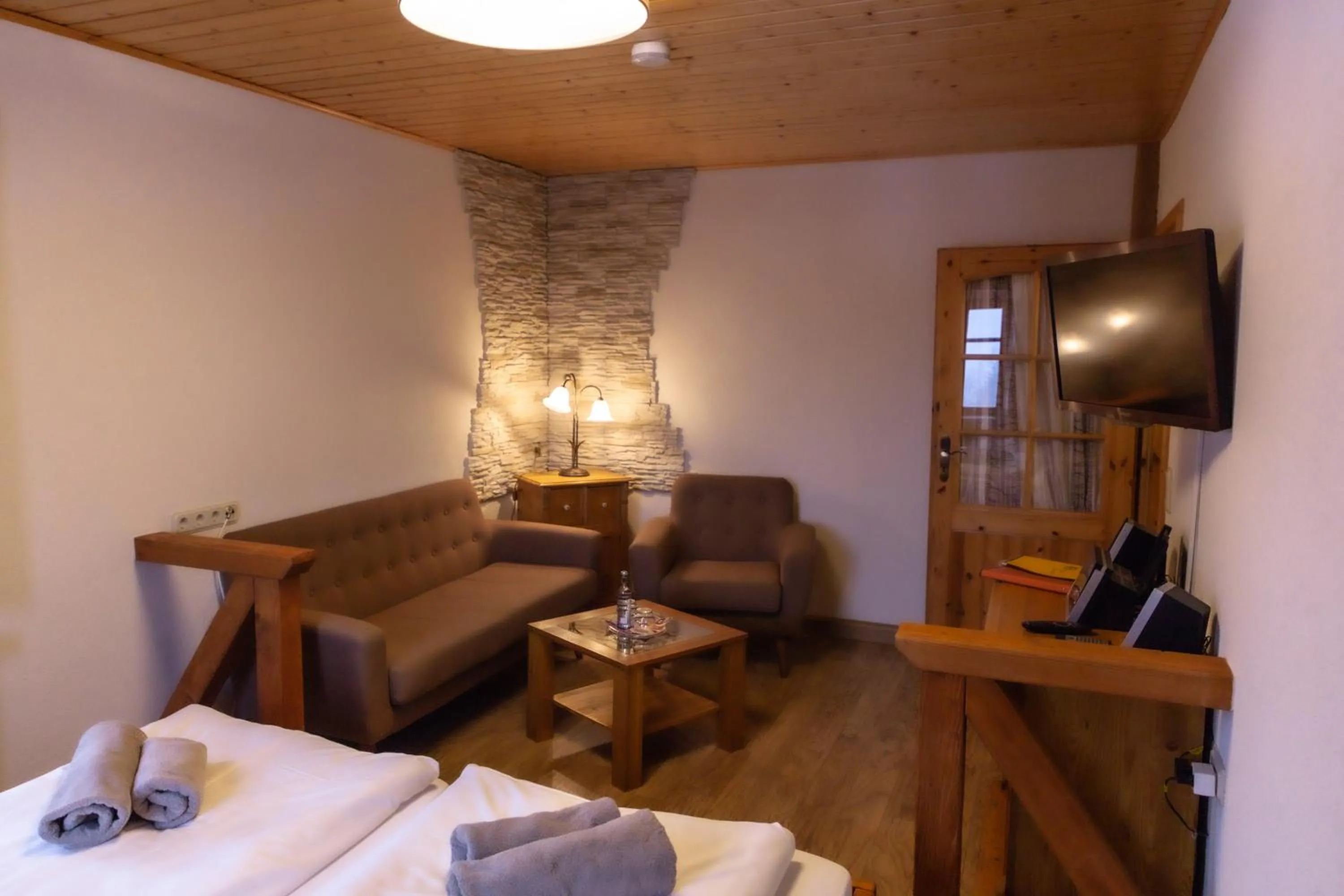 Seating area, Bed in Naturhotel Gasthof Bärenfels