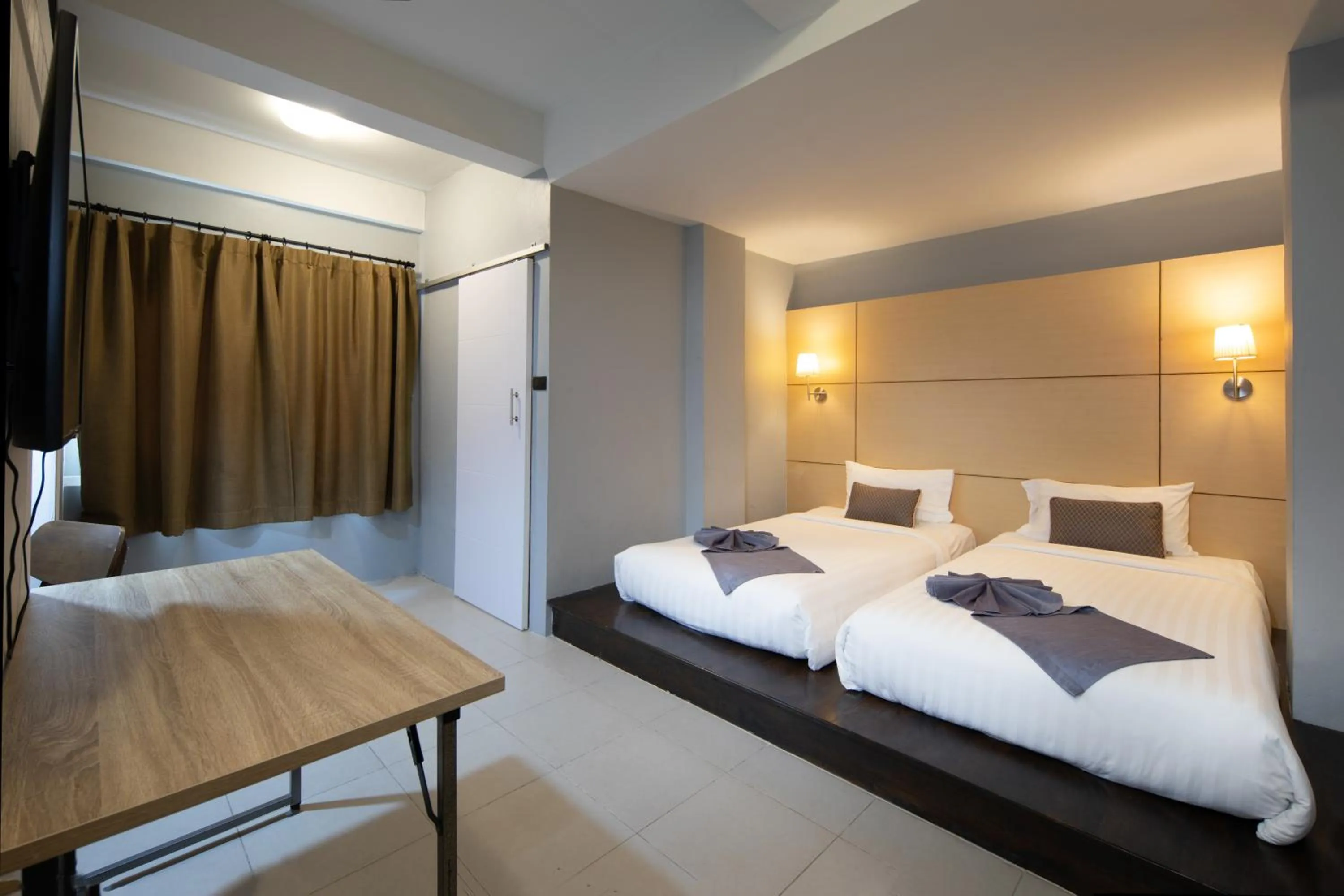 Bed in Montree Phuket Hotel