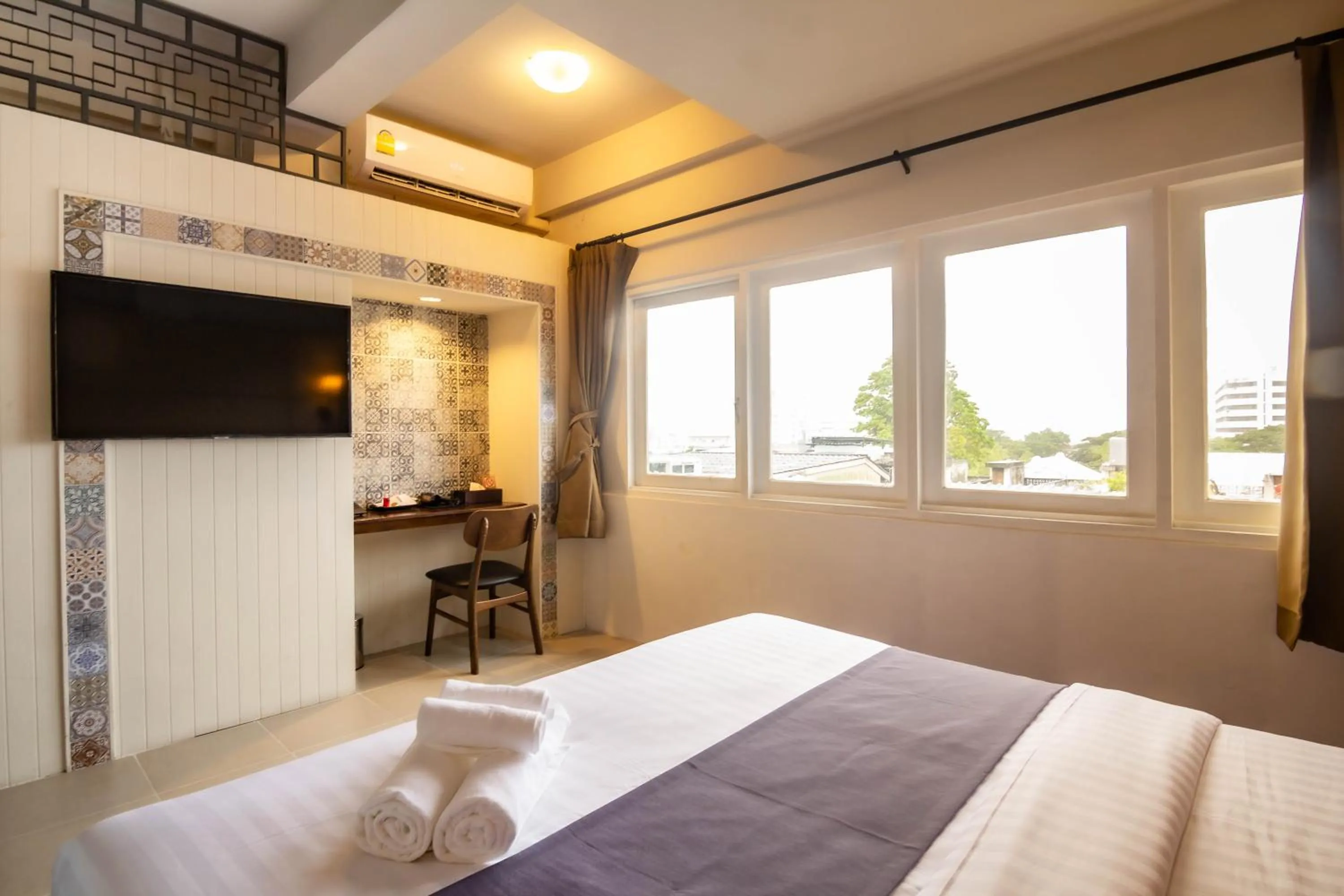 Bed in Montree Phuket Hotel