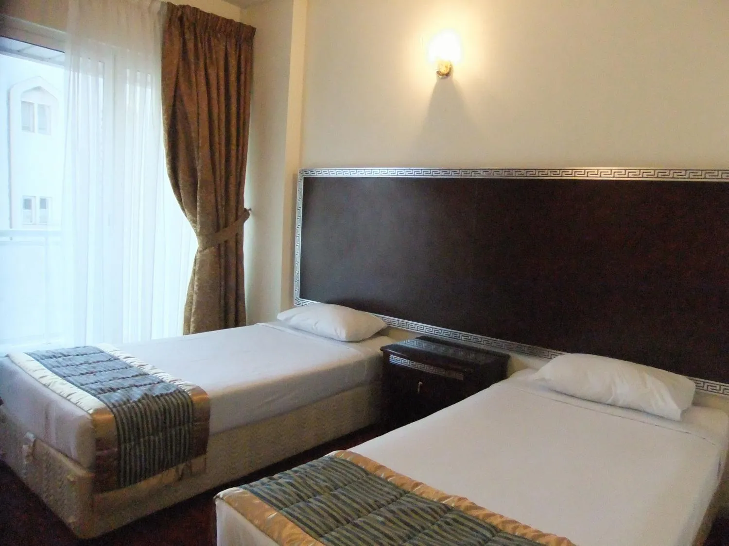 Bed in Royal Plaza Hotel Apartments