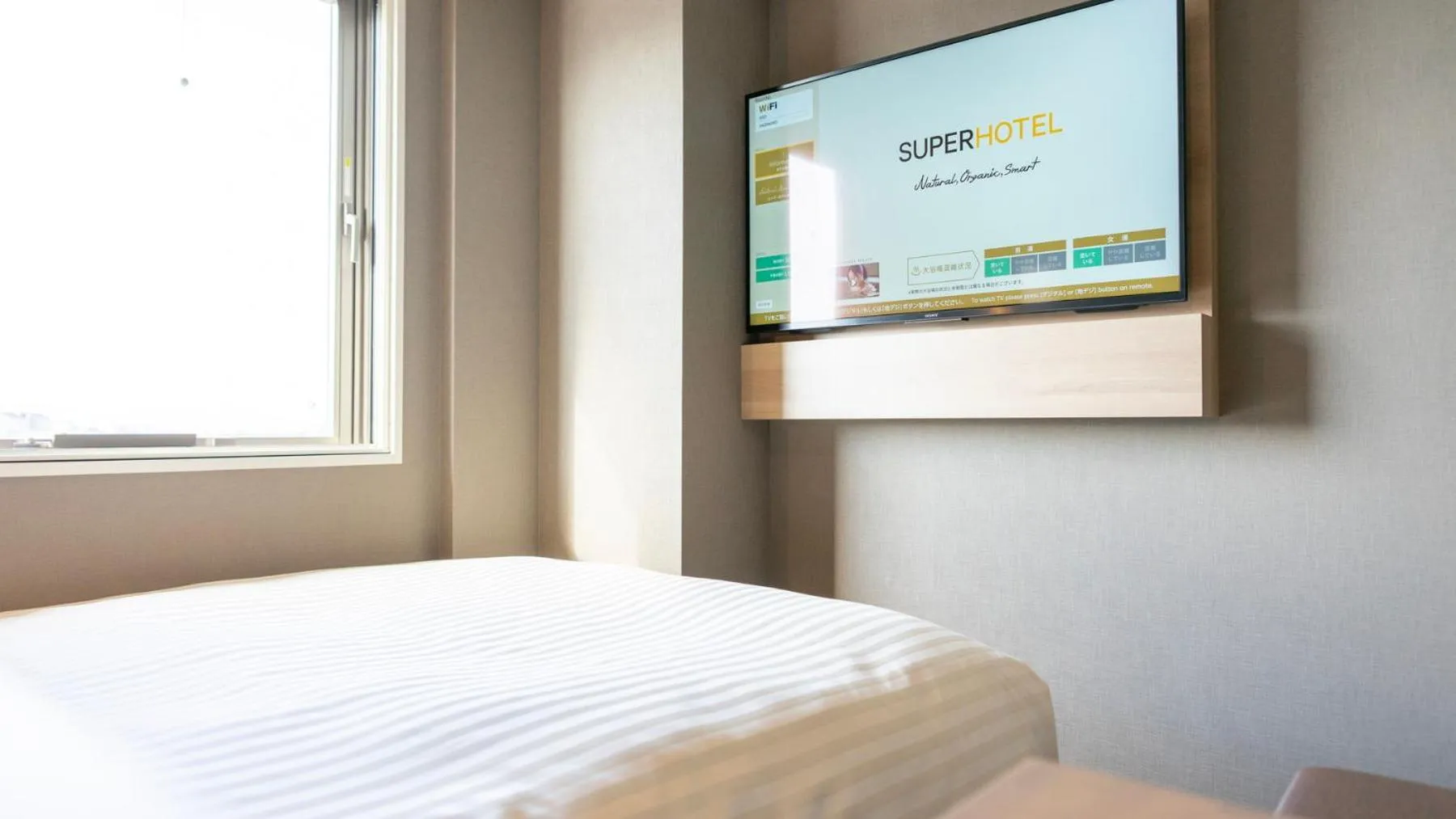 Bed in Super Hotel Kanku Kumatoriekimae