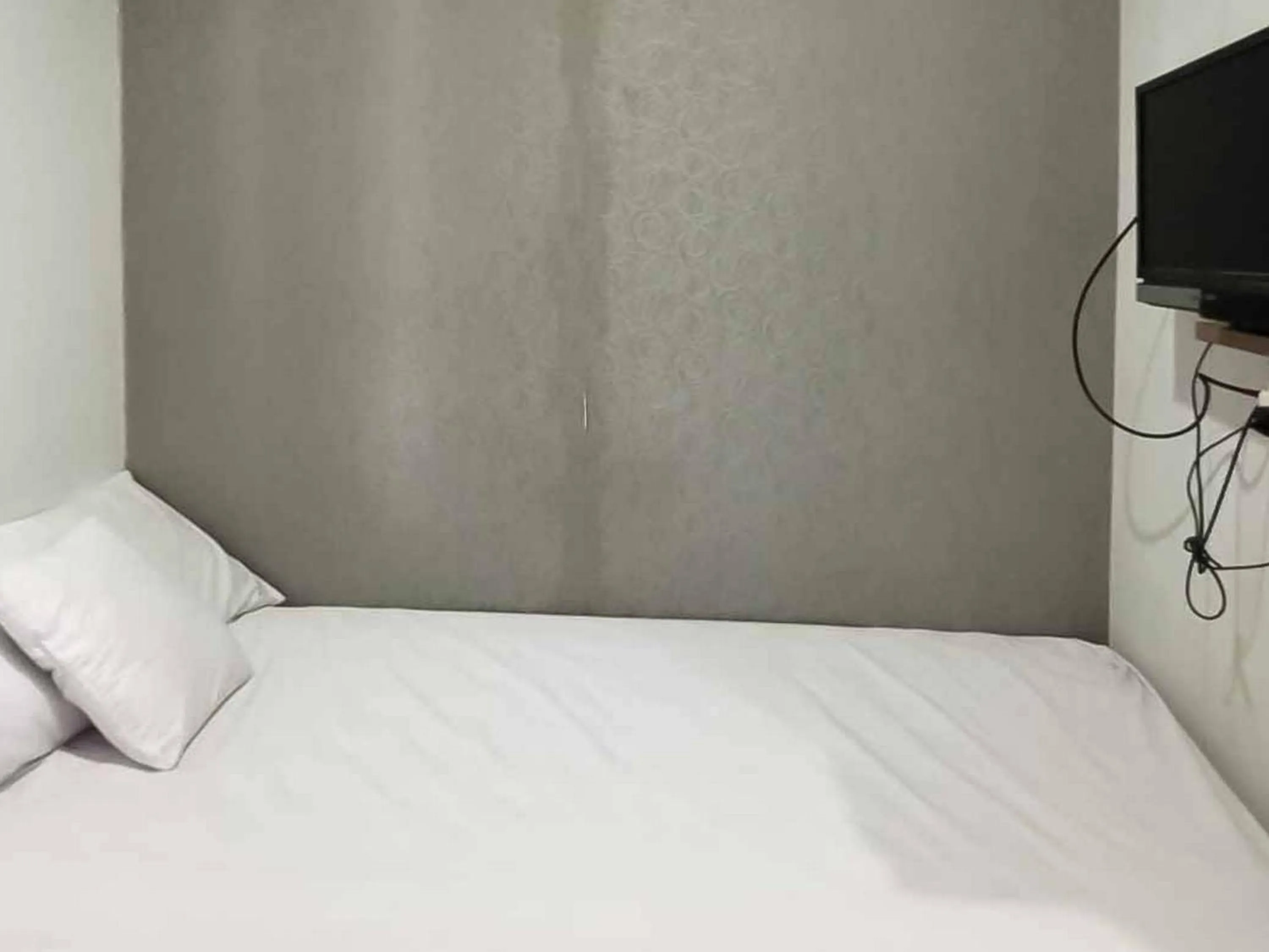 Bed in Aimer Guest House Syariah Mitra RedDoorz