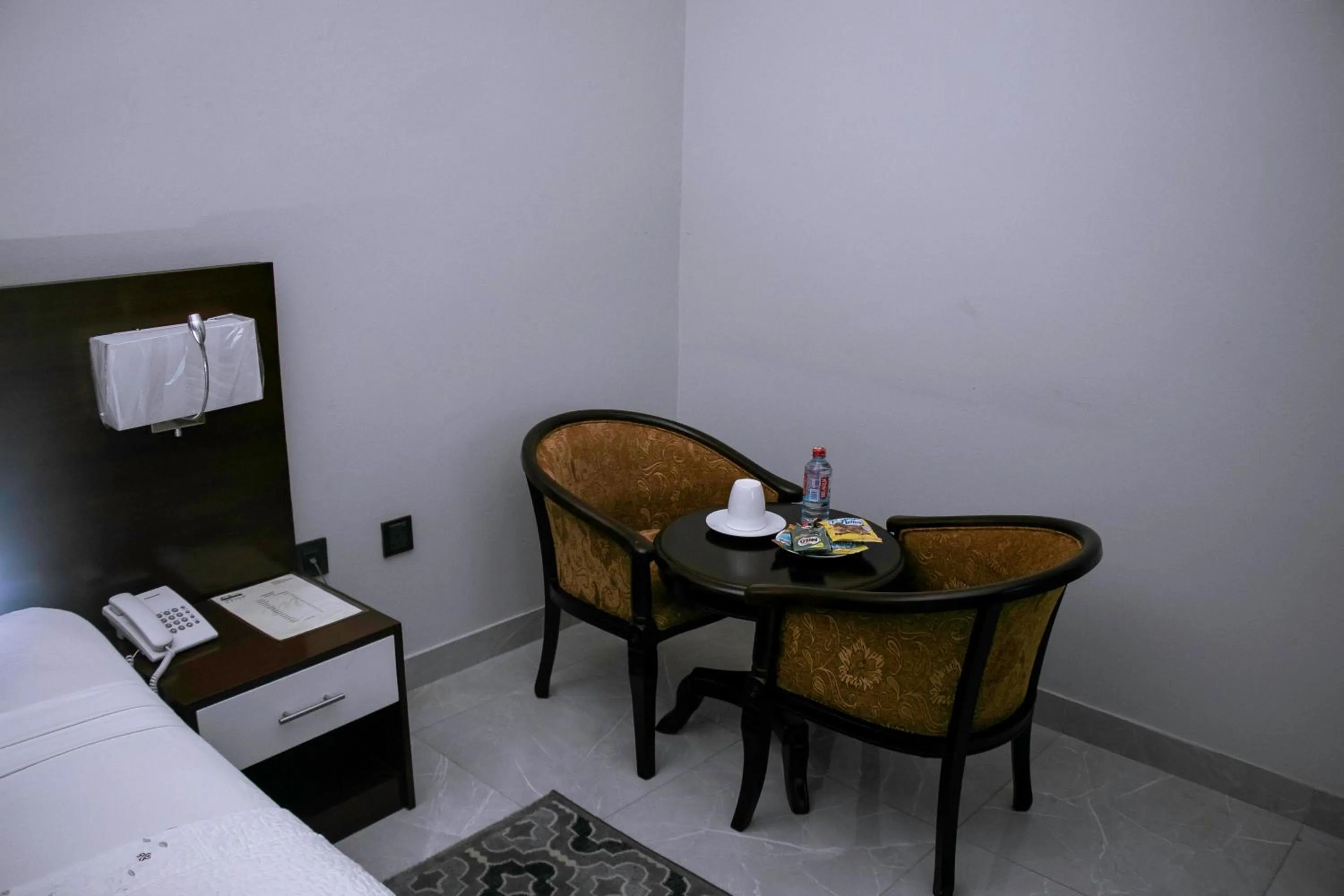 Seating area, Bed in Monarch Hotel