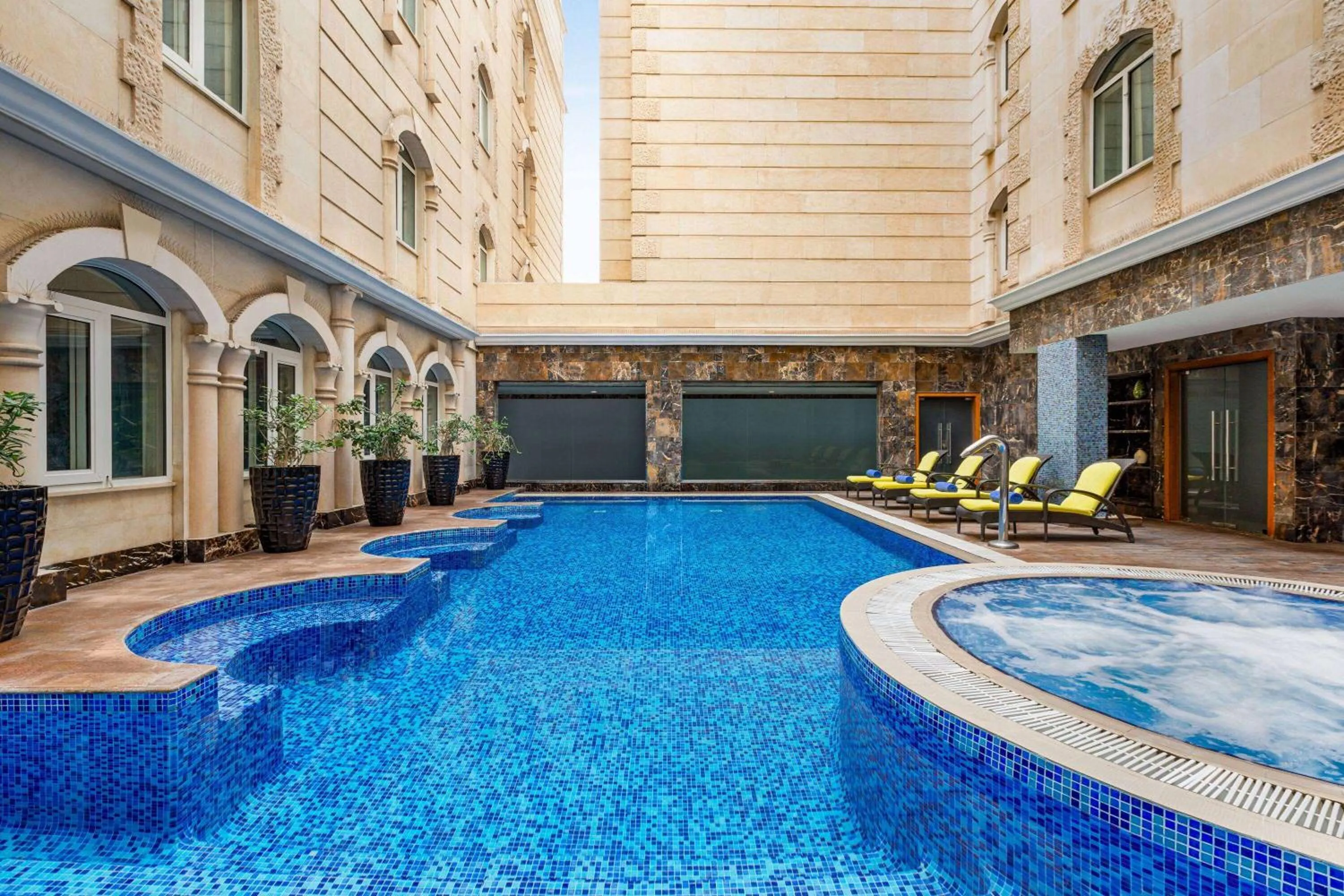Swimming pool in Grand Regency Doha, Trademark Collection by Wyndham