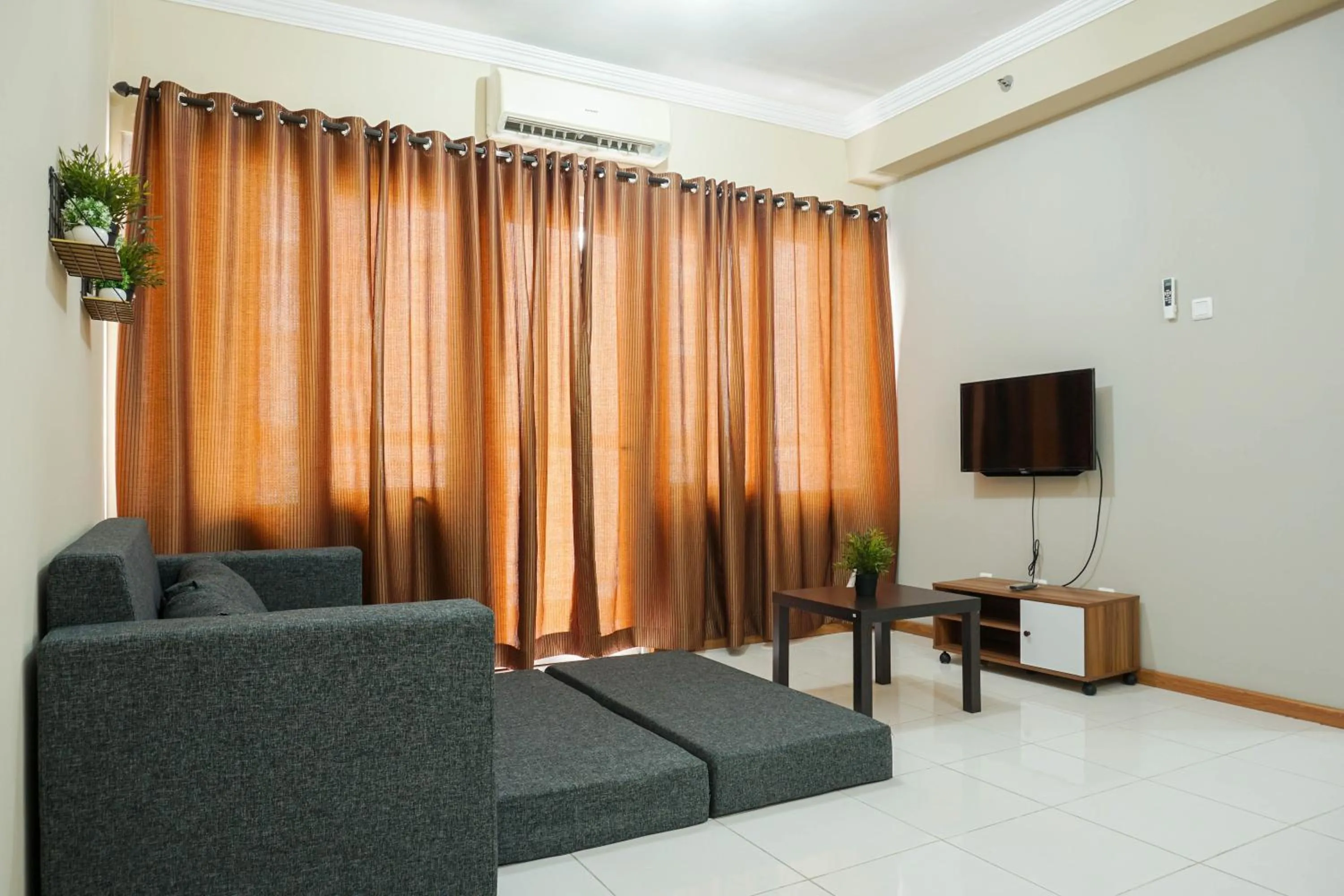 Living room in Spacious 3BR Residence at Grand Palace Kemayoran Apartment By Travelio