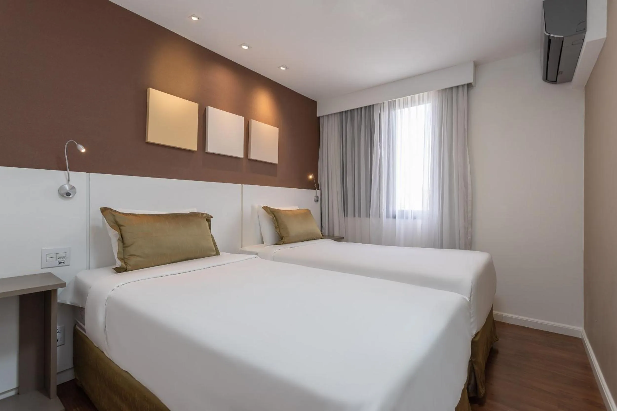 Bed in Paulista Suites by Charlie