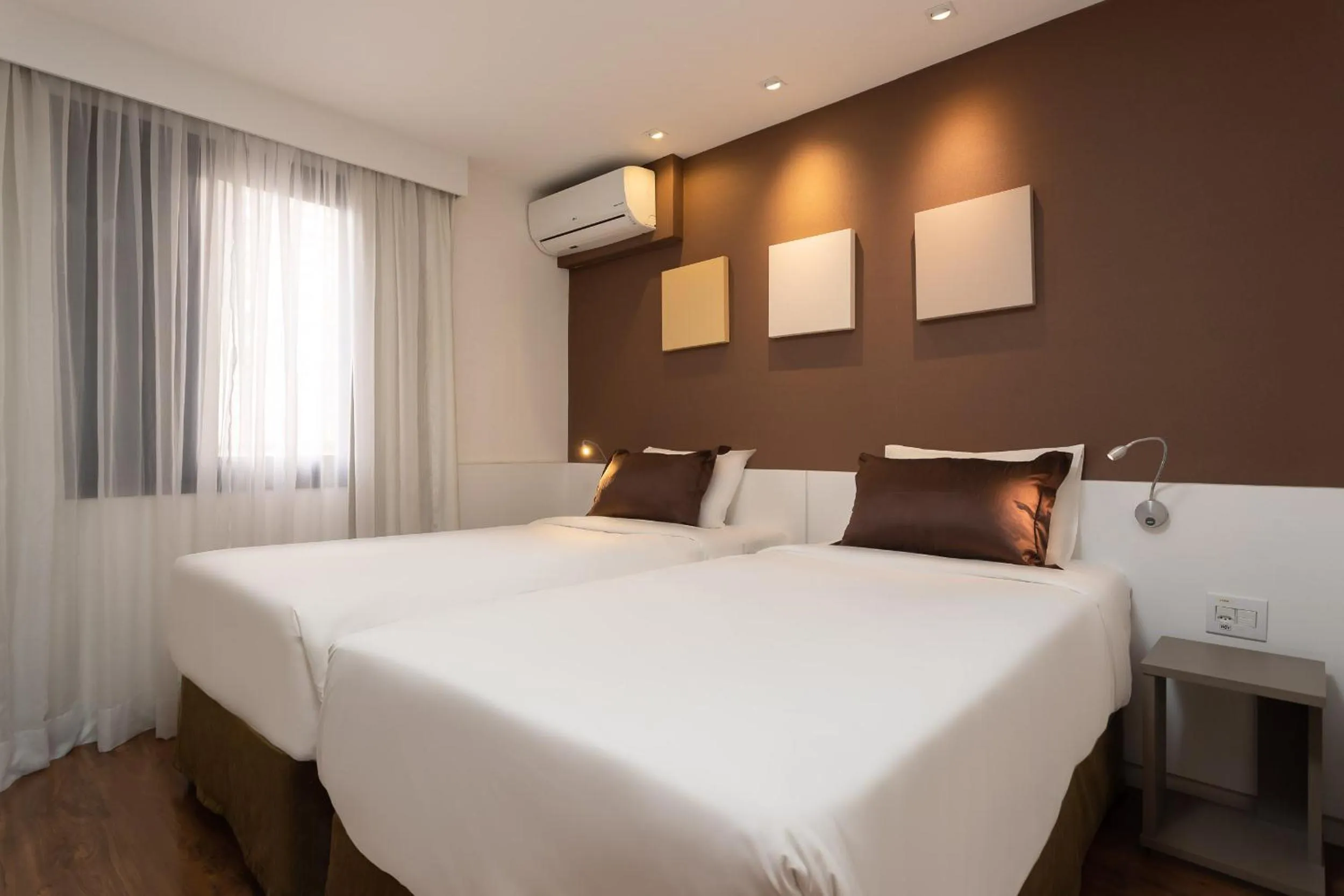 Bed in Paulista Suites by Charlie