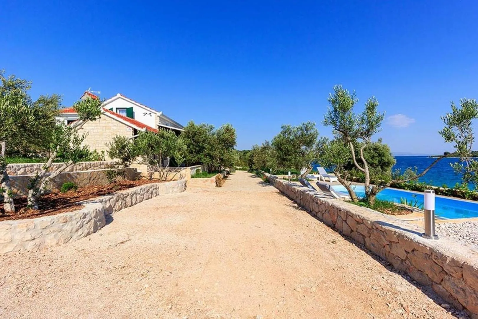 Property building in Luxury Beachfront Villa Dalmatino Trogir with private pool right at the beach in Okrug Gornji - Ciovo