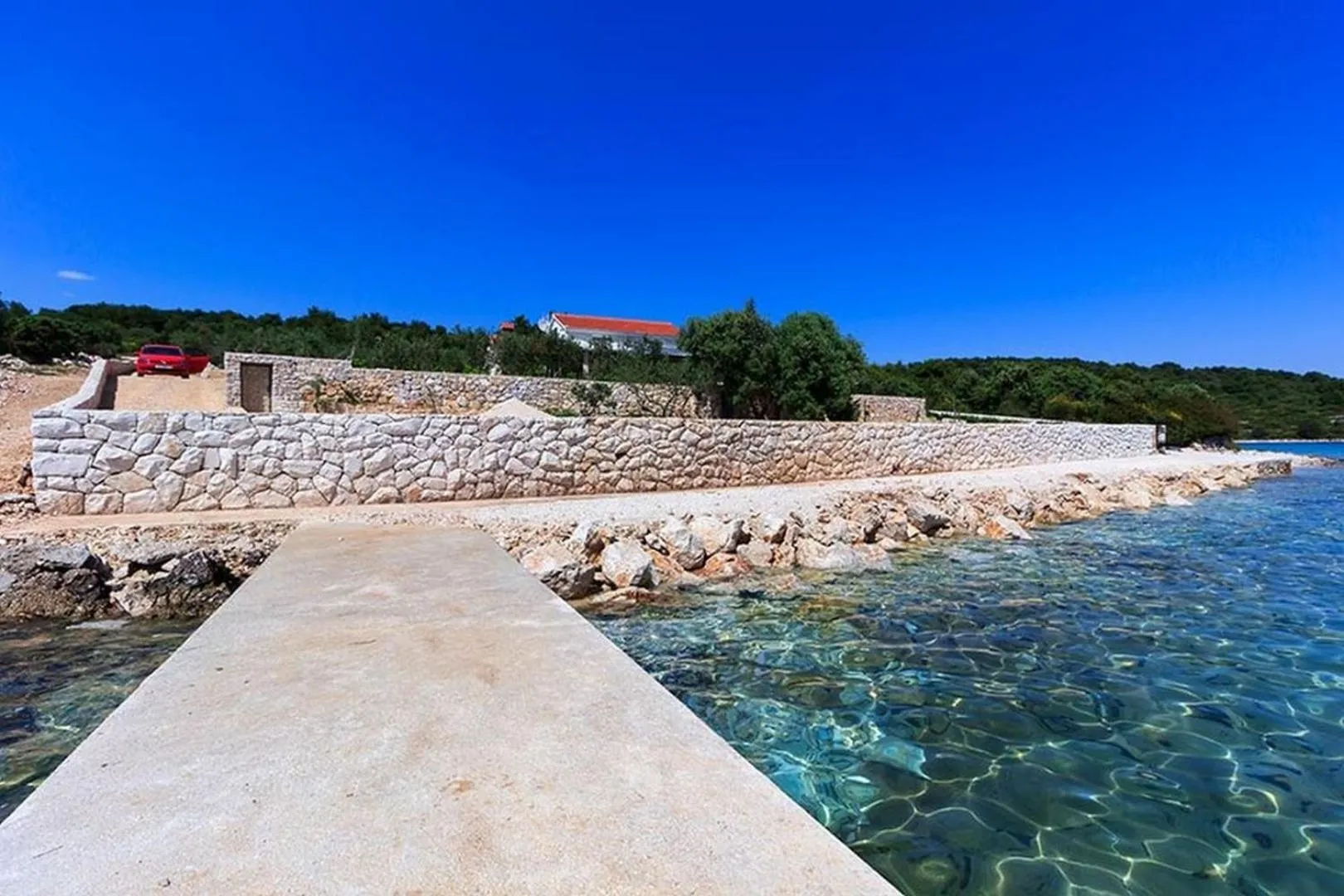 Property building in Luxury Beachfront Villa Dalmatino Trogir with private pool right at the beach in Okrug Gornji - Ciovo
