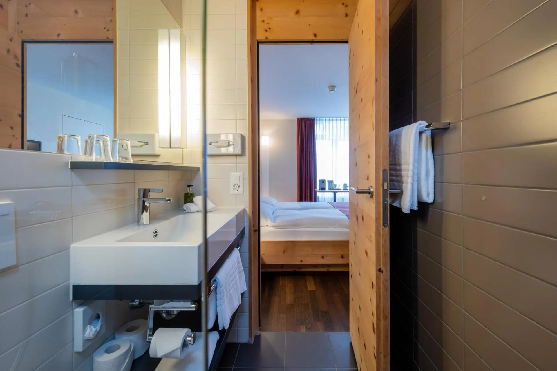 Bathroom, Bed in Hotel Schweizerhof Sils Maria, a Faern Collection Hotel