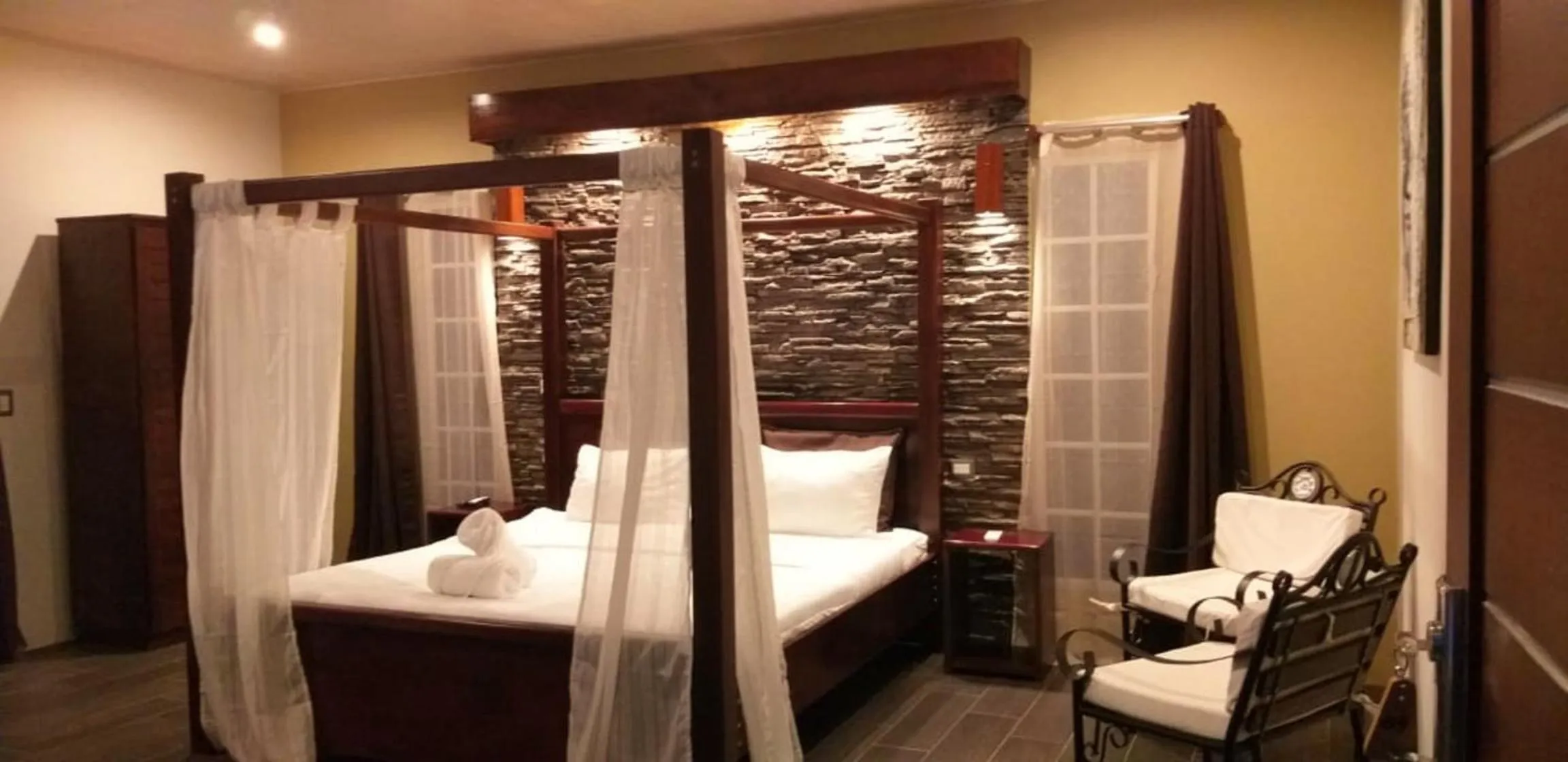 Bed in Tropical Suites & Villas