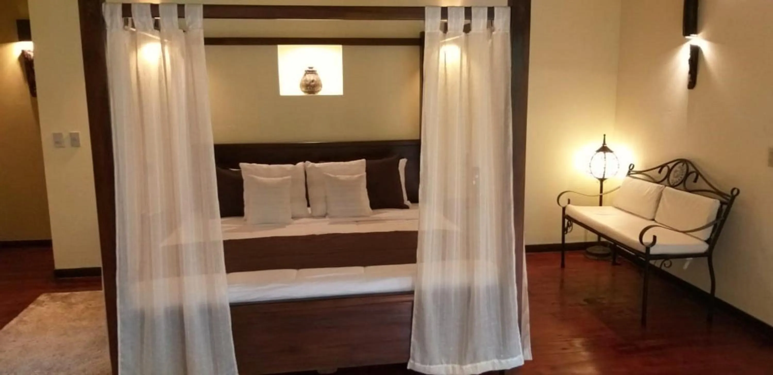 Bed in Tropical Suites & Villas