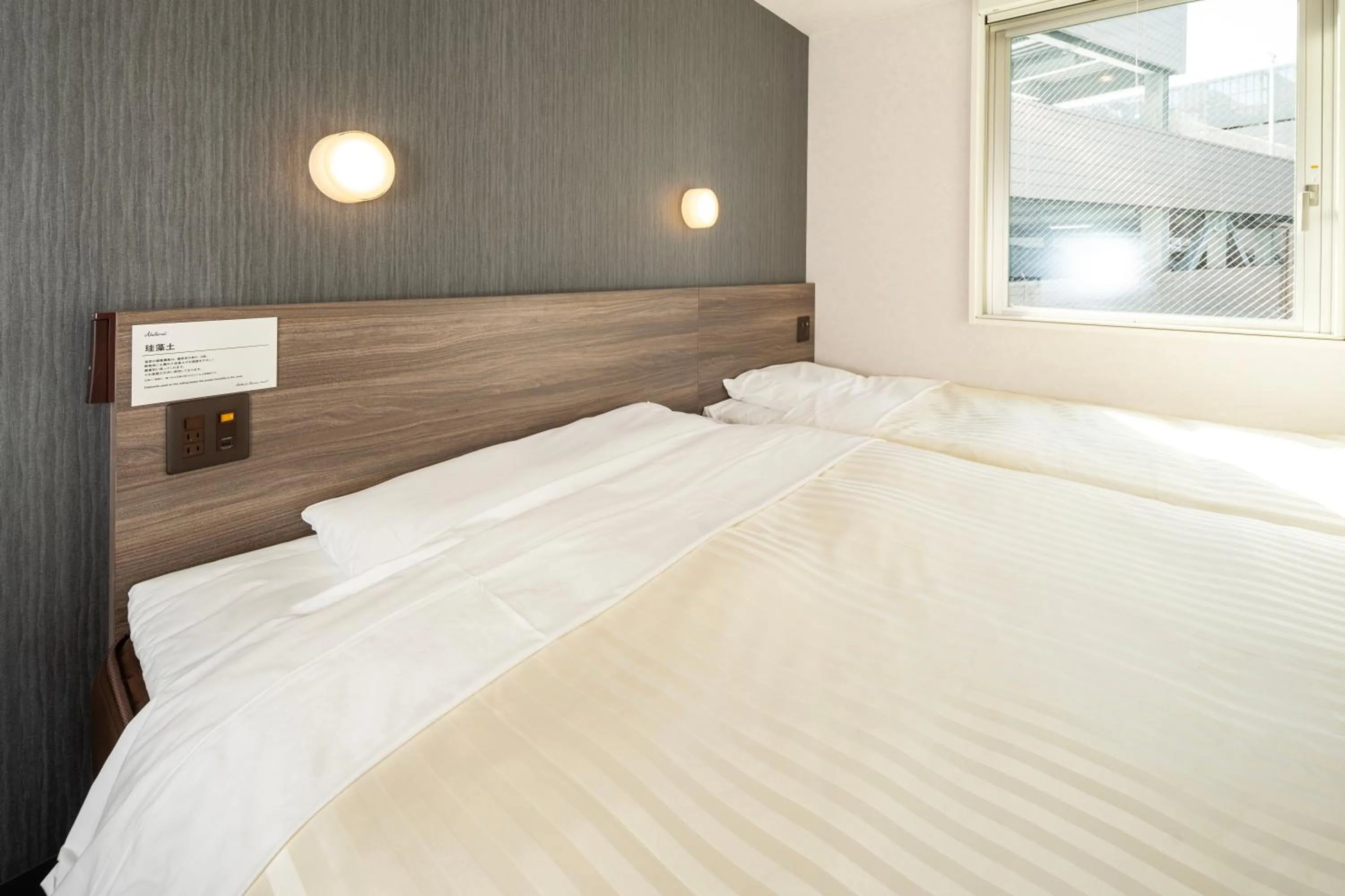 Bed in Super Hotel Hiroshima Yagenboridori