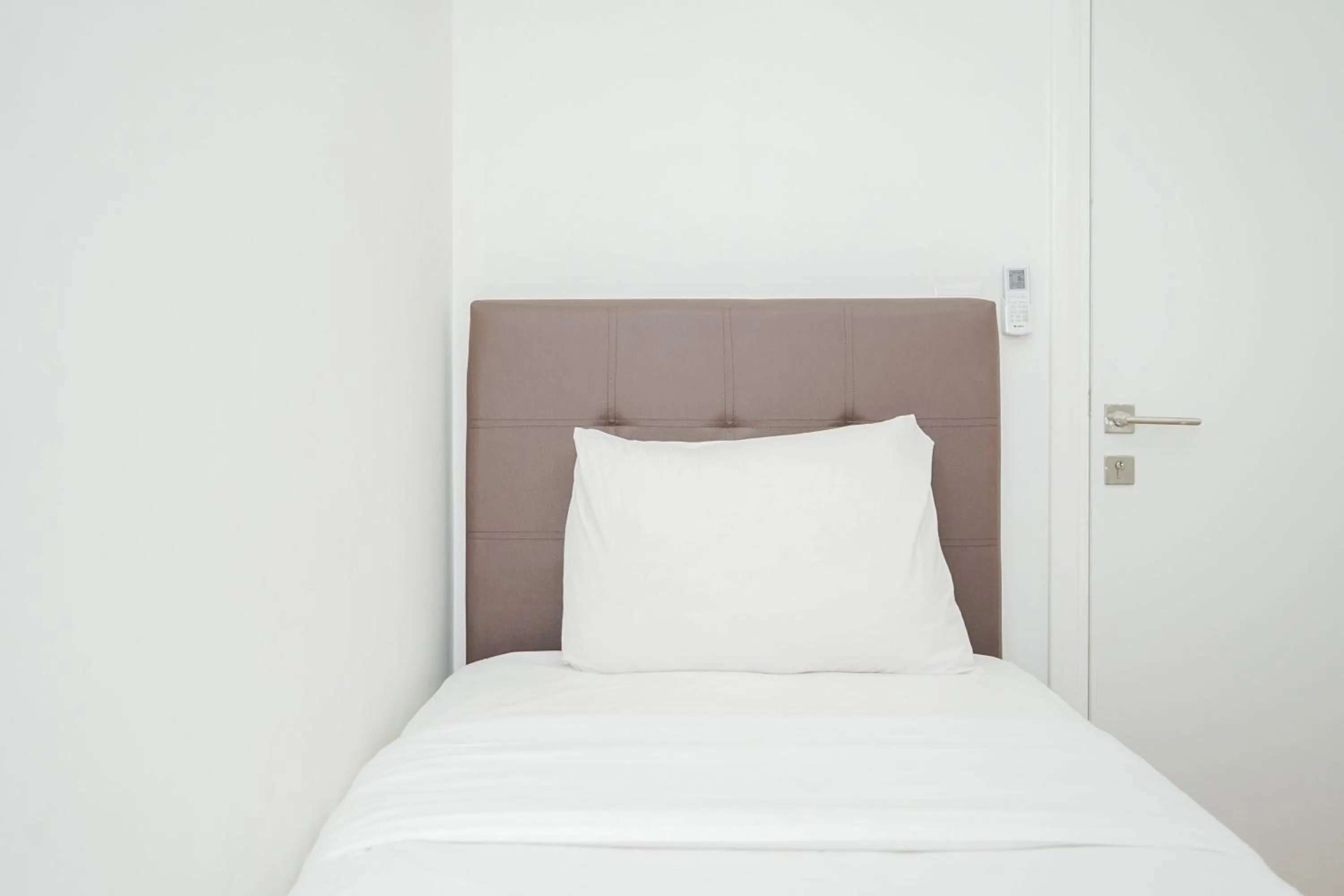 Bed in Cozy 2BR Apartment at Tuscany Residences With Garden View By Travelio