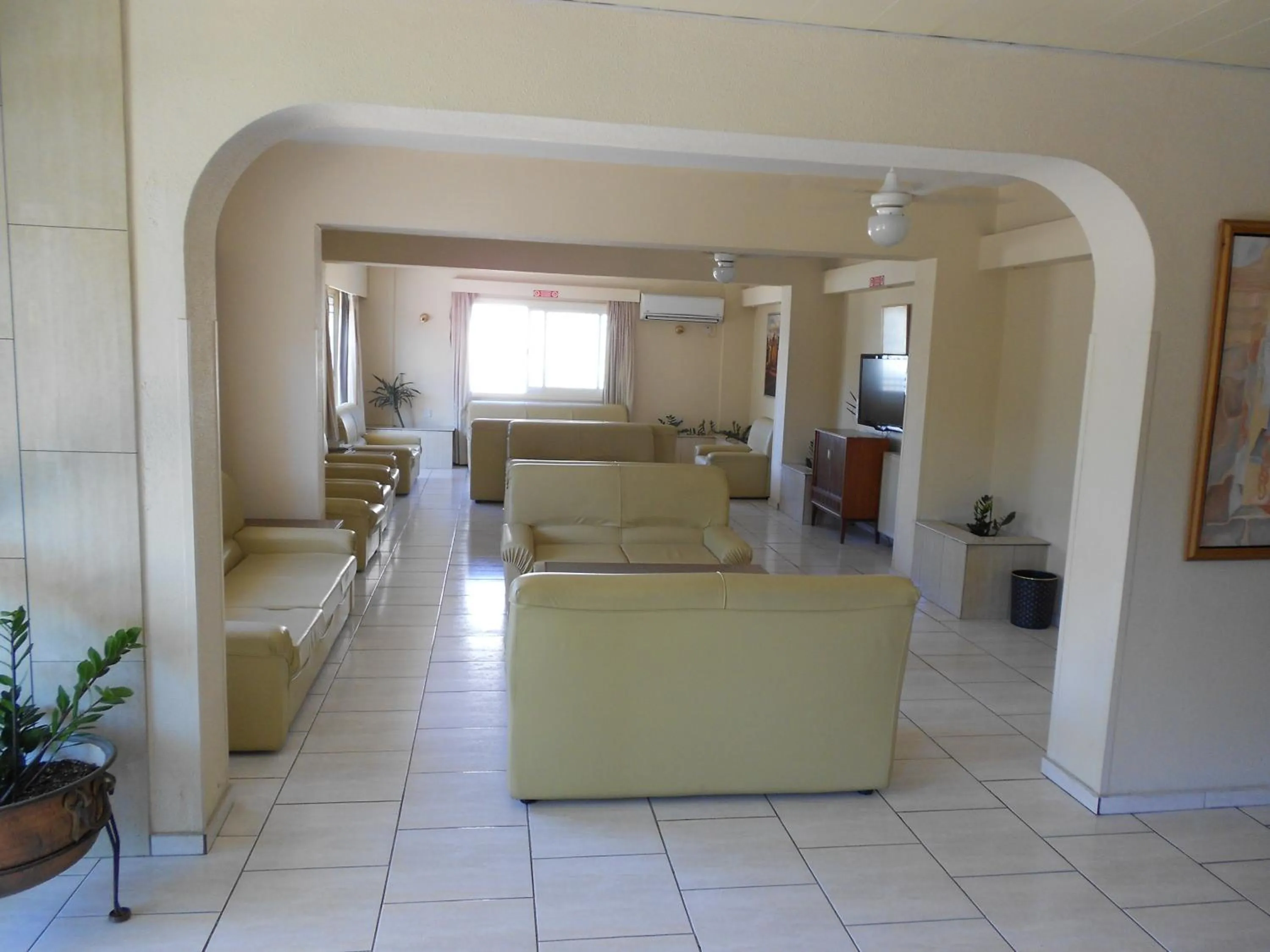 Communal lounge/ TV room in Denis Hotel