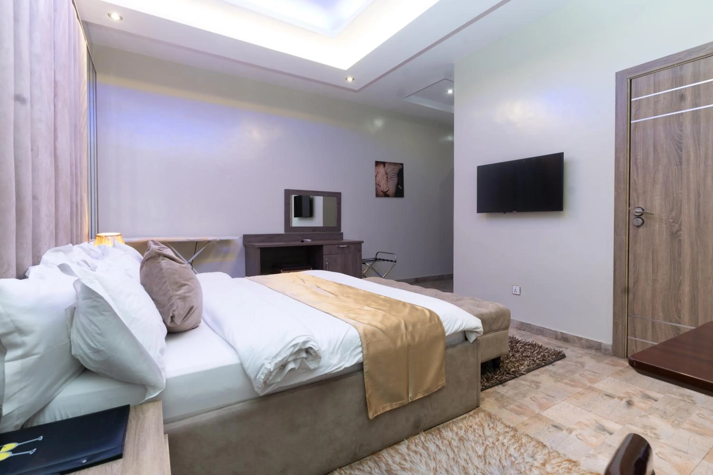 Bed in God's Touch Apartments Signature