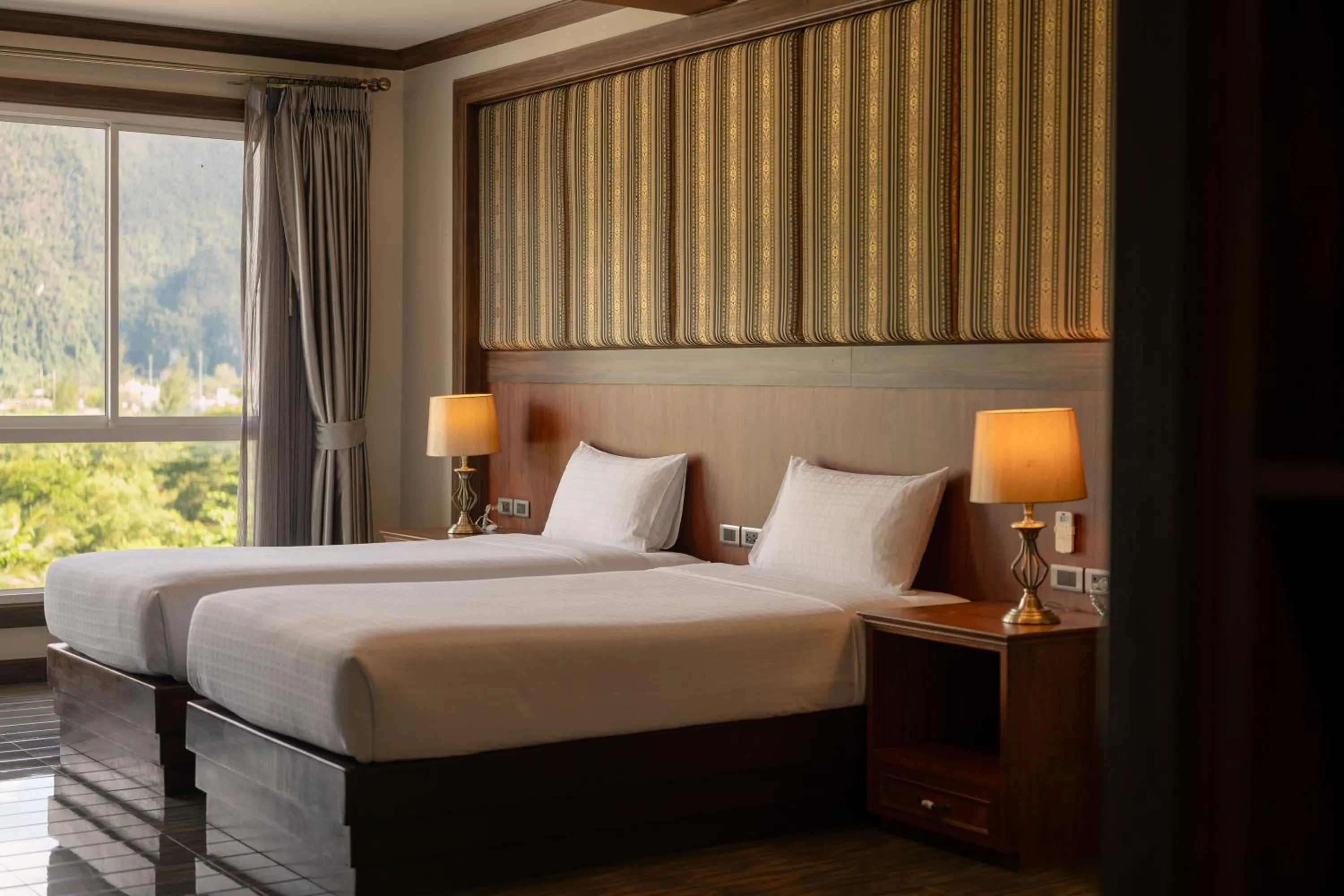 Bed in Le Erawan Phang Nga Hotel