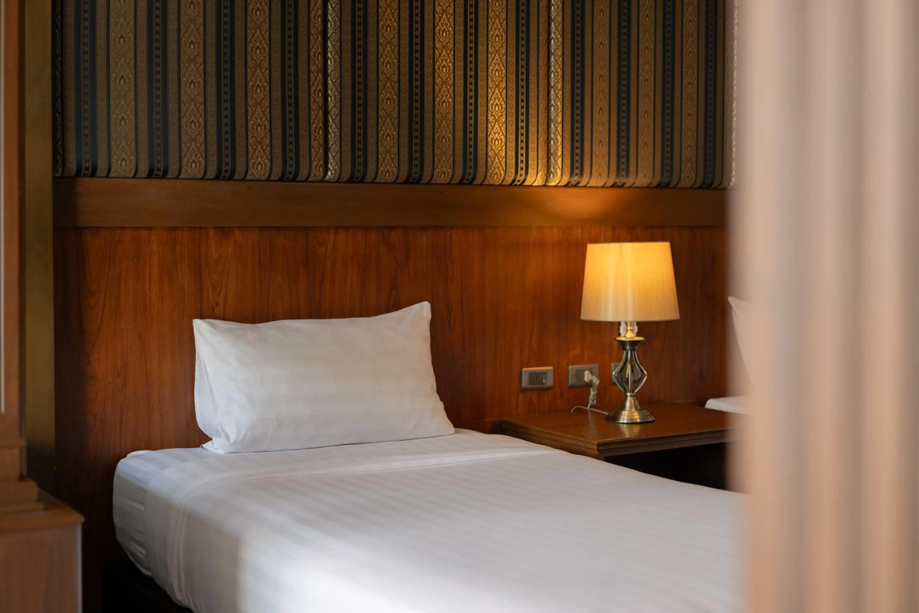 Bed in Le Erawan Phang Nga Hotel