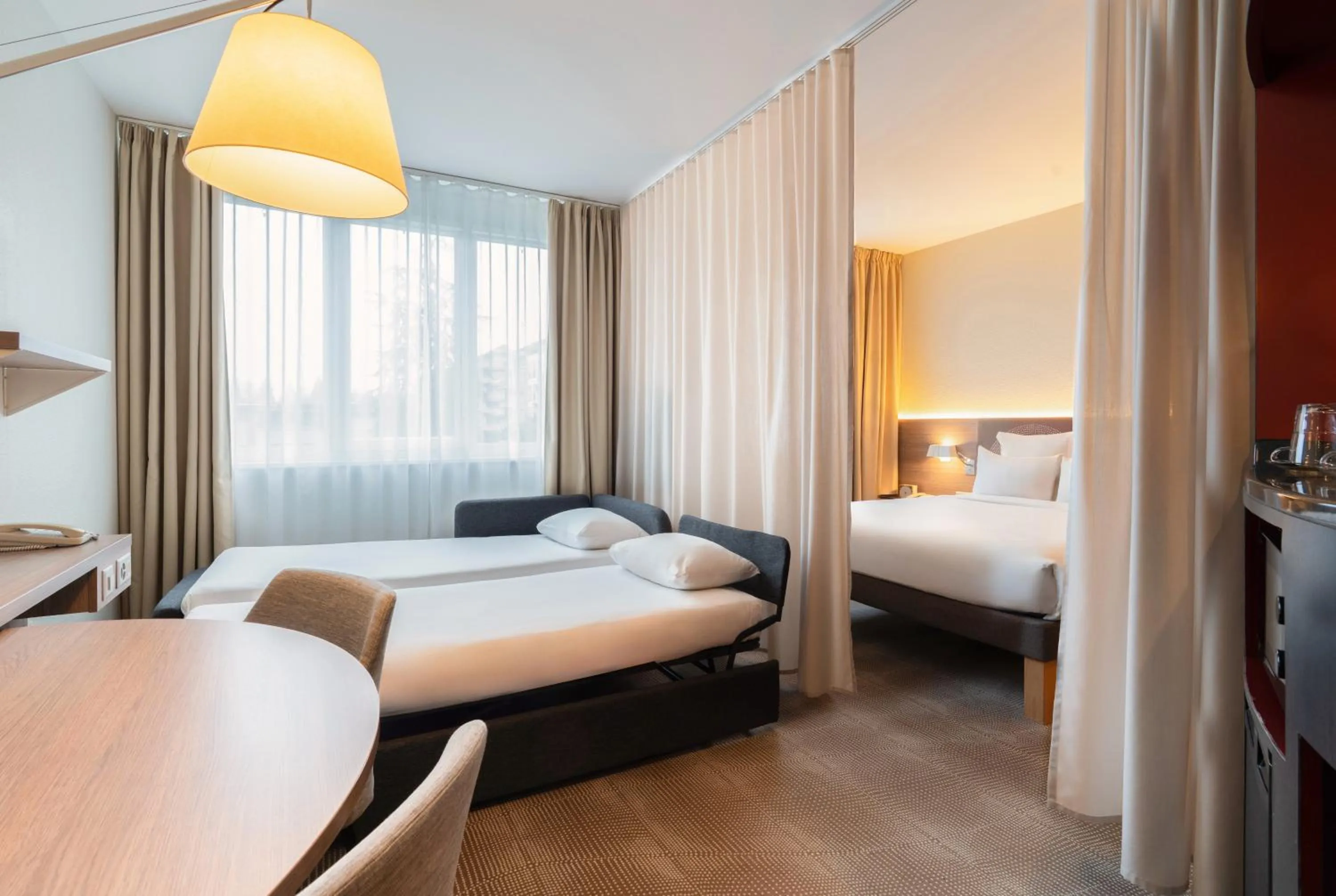 Bed in Novotel Suites Genève Aéroport