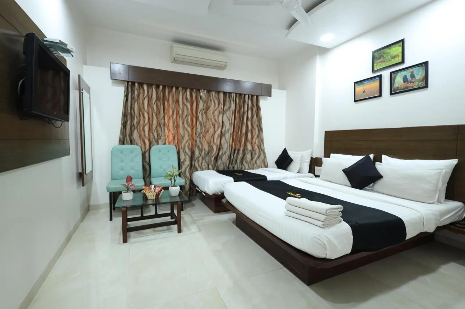 Photo of the whole room, Bed in Saish Hotel Shirdi