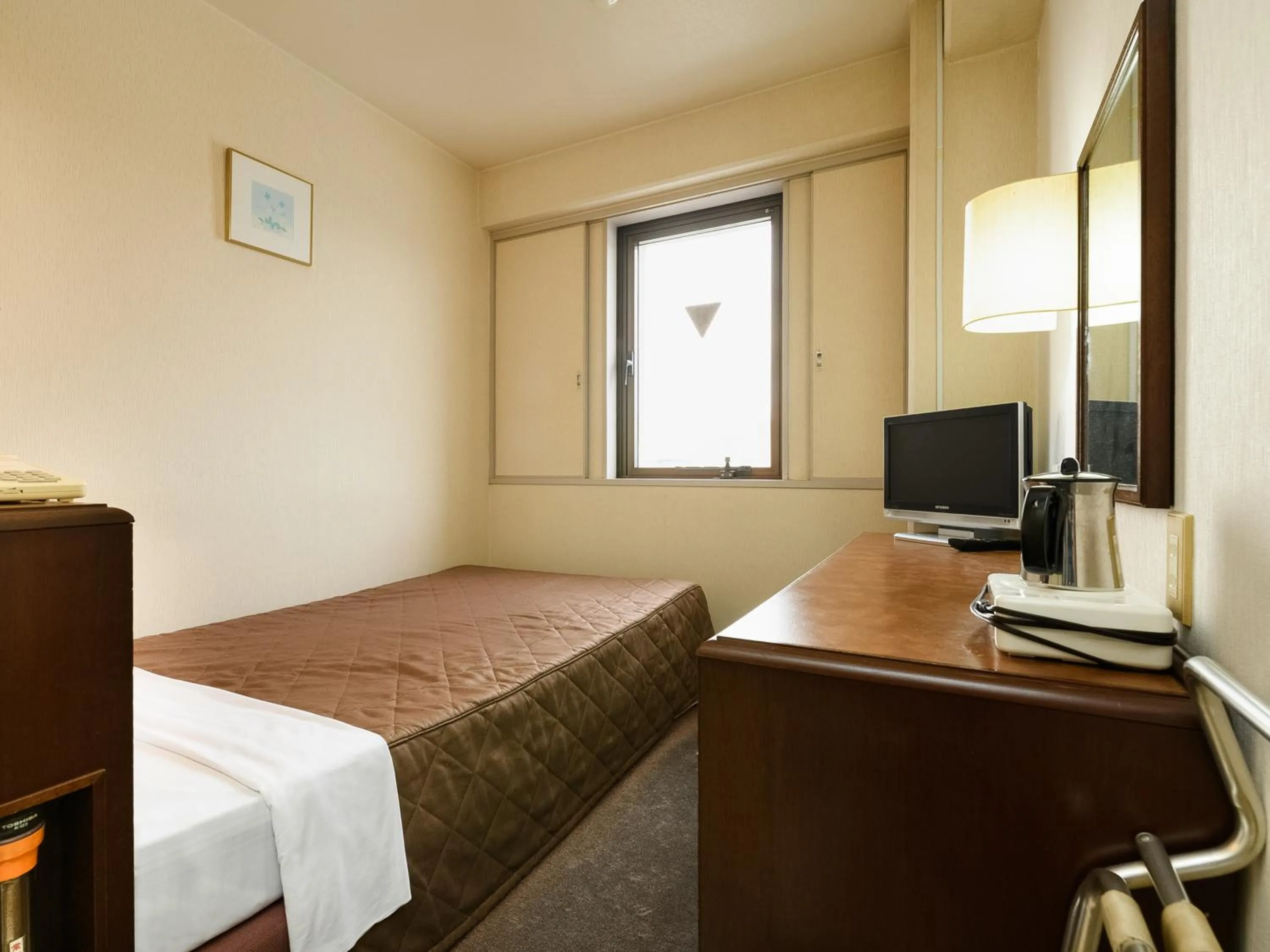 Bed in Tabist Kameyama Daiichi Hotel