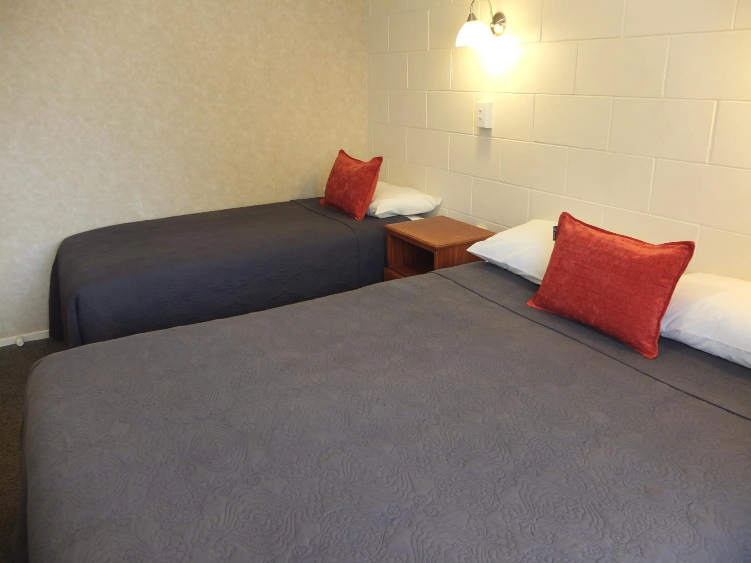 Bed in Colonial Court Motel