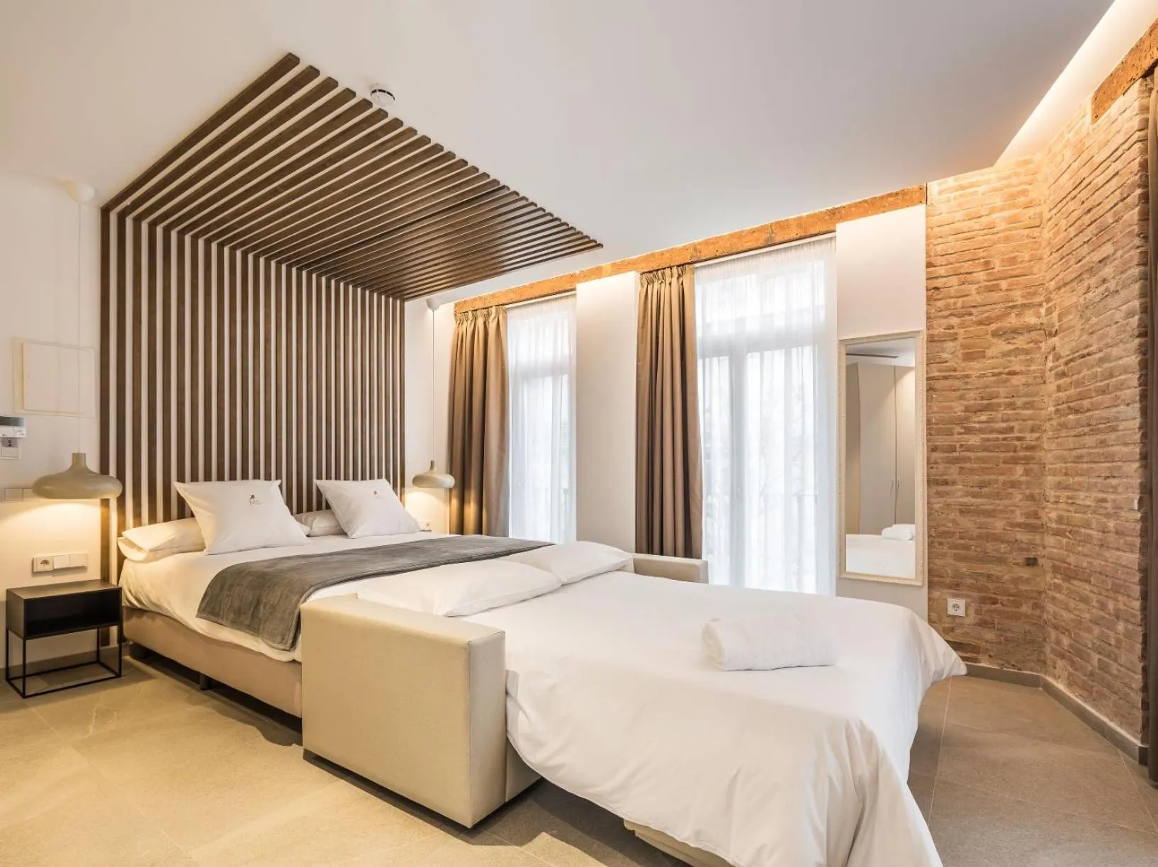 Bed in Mon Suites Benlliure