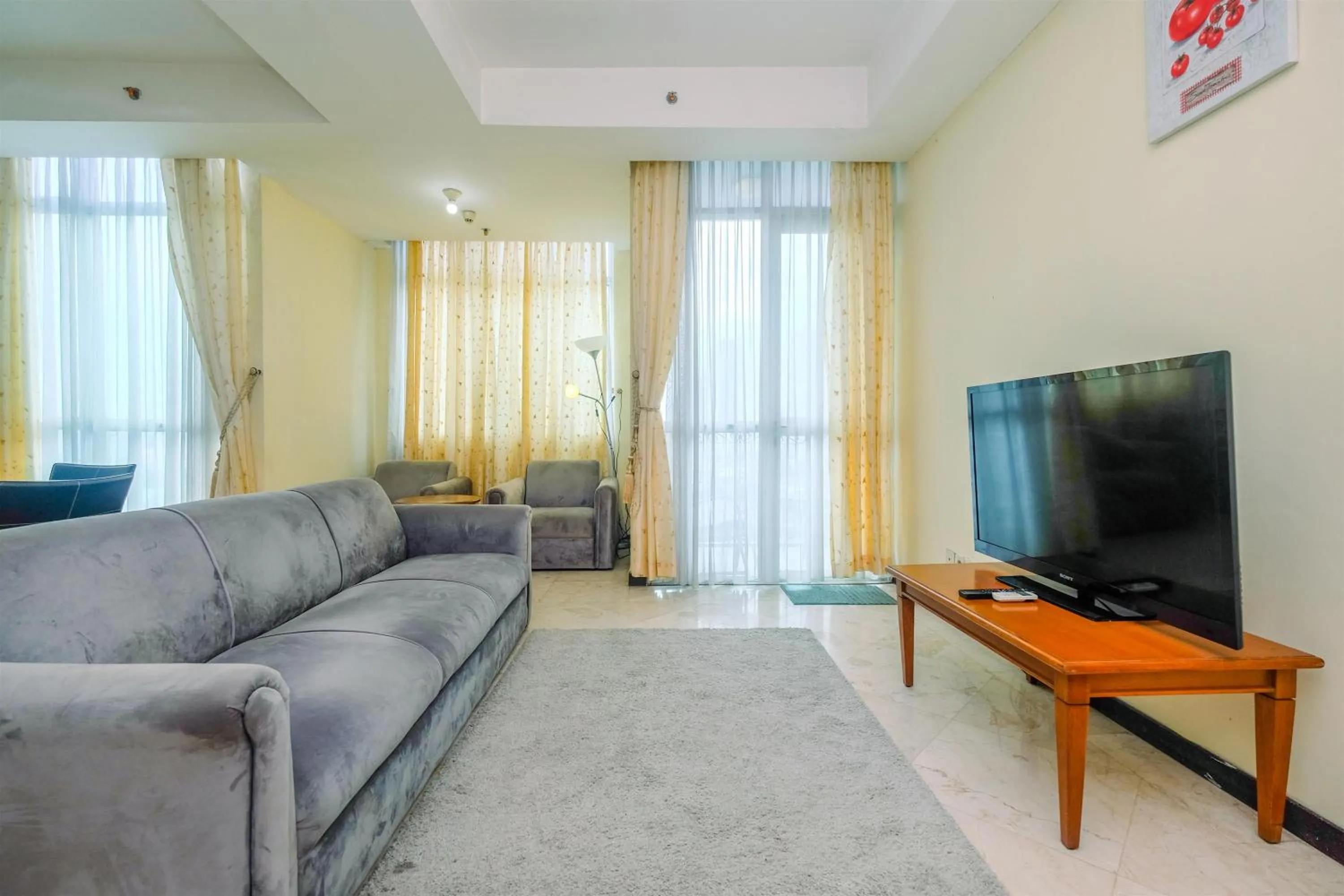 Living room in Exclusive with City View 3BR Apartment Bellagio Residence By Travelio